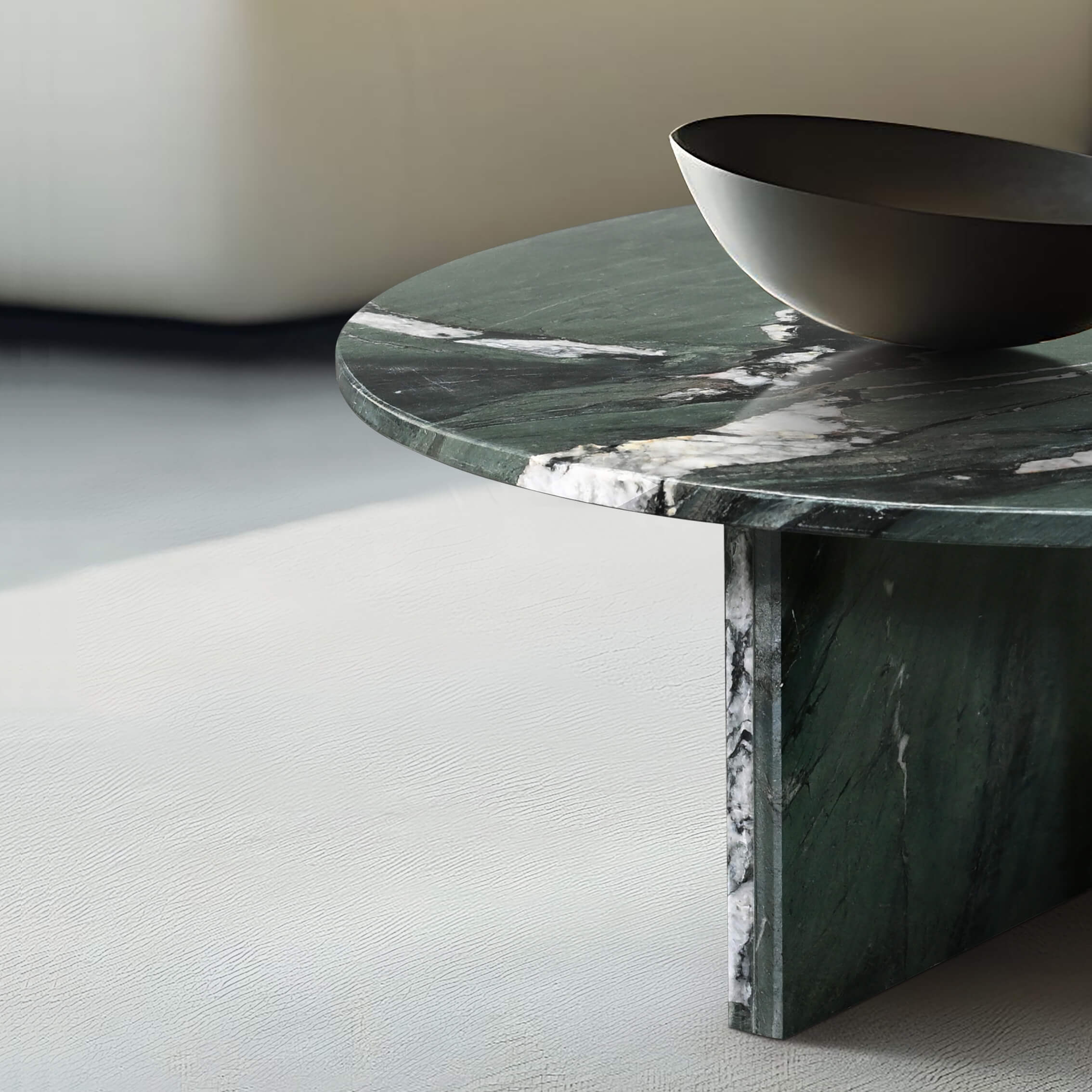 Close-up showing the thick polished edge and precise joinery of the green marble coffee table base, highlighting premium craftsmanship.