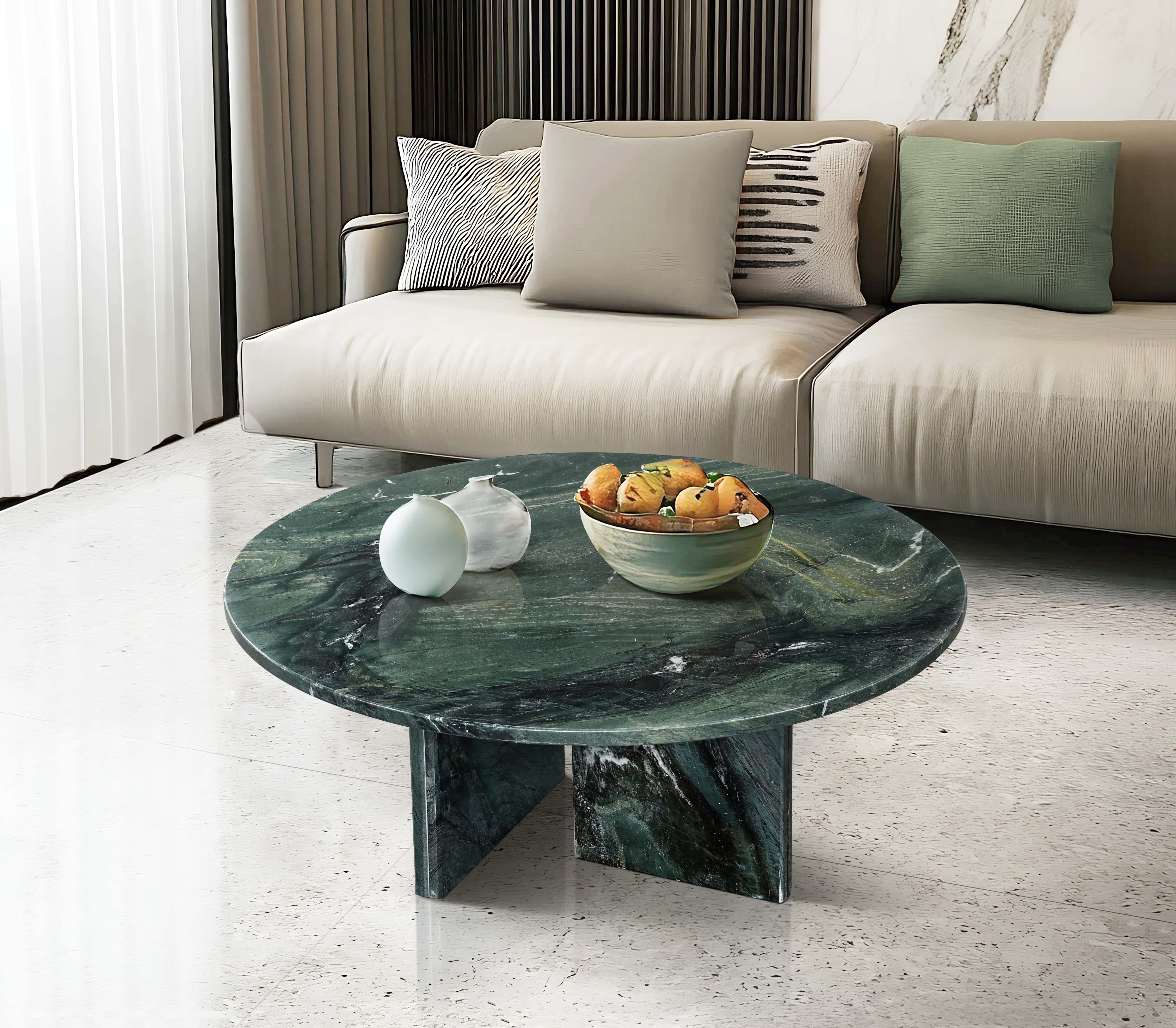 Elegant living room setup featuring the Diamond Green marble coffee table styled with modern vases and a fruit bowl, highlighting the stone's polished luster against a terrazzo floor.