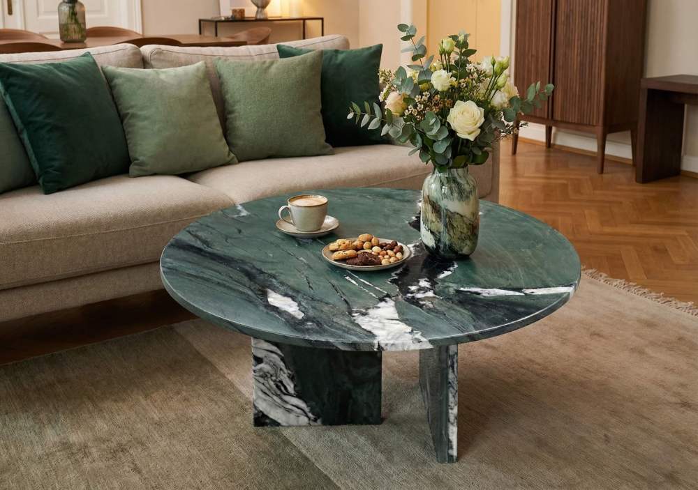 Cozy living room styling idea: matching velvet green pillows with the emerald green natural stone coffee table for a cohesive nature-inspired theme.