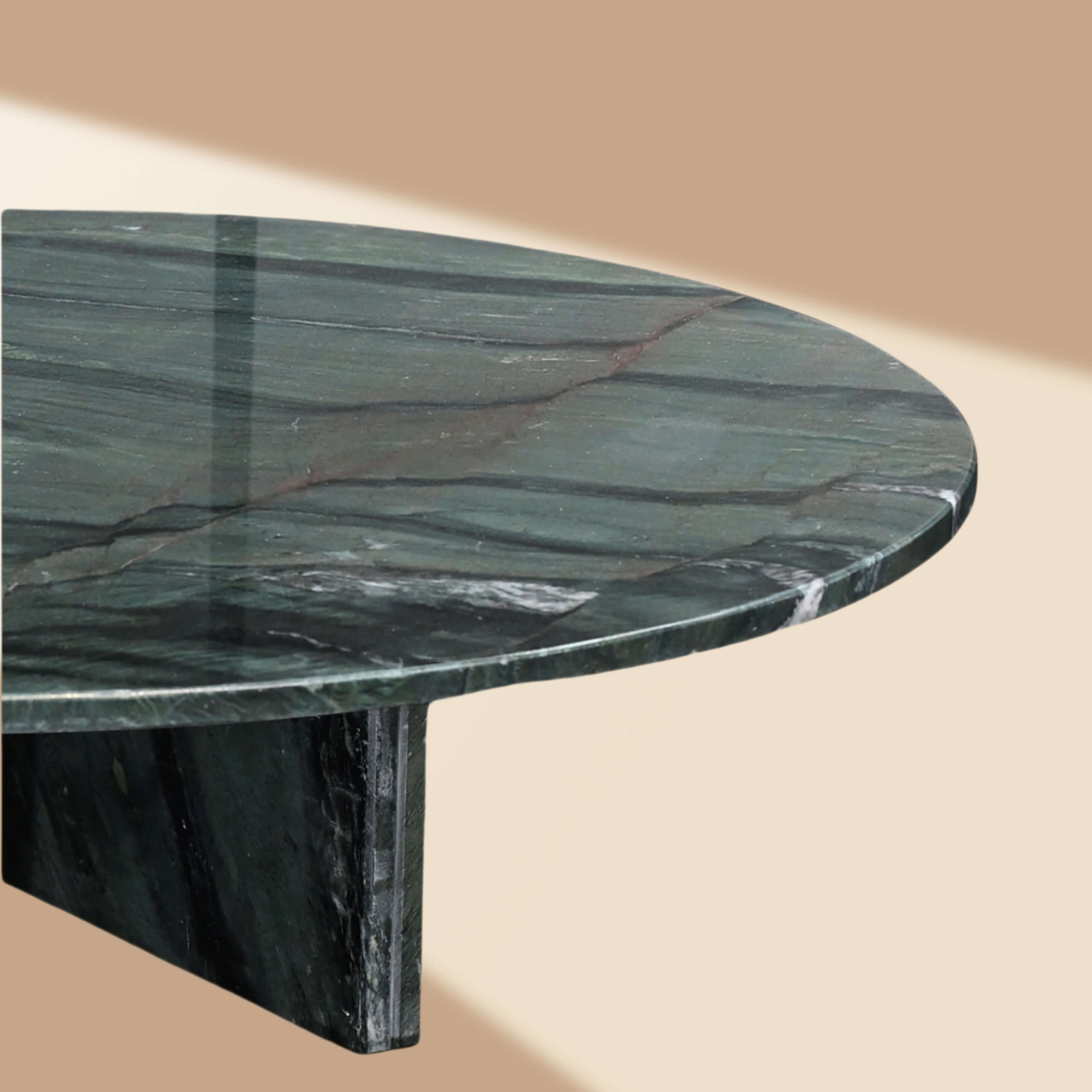 Detailed view of the hand-polished marble edge and hidden metal base of the round coffee table.