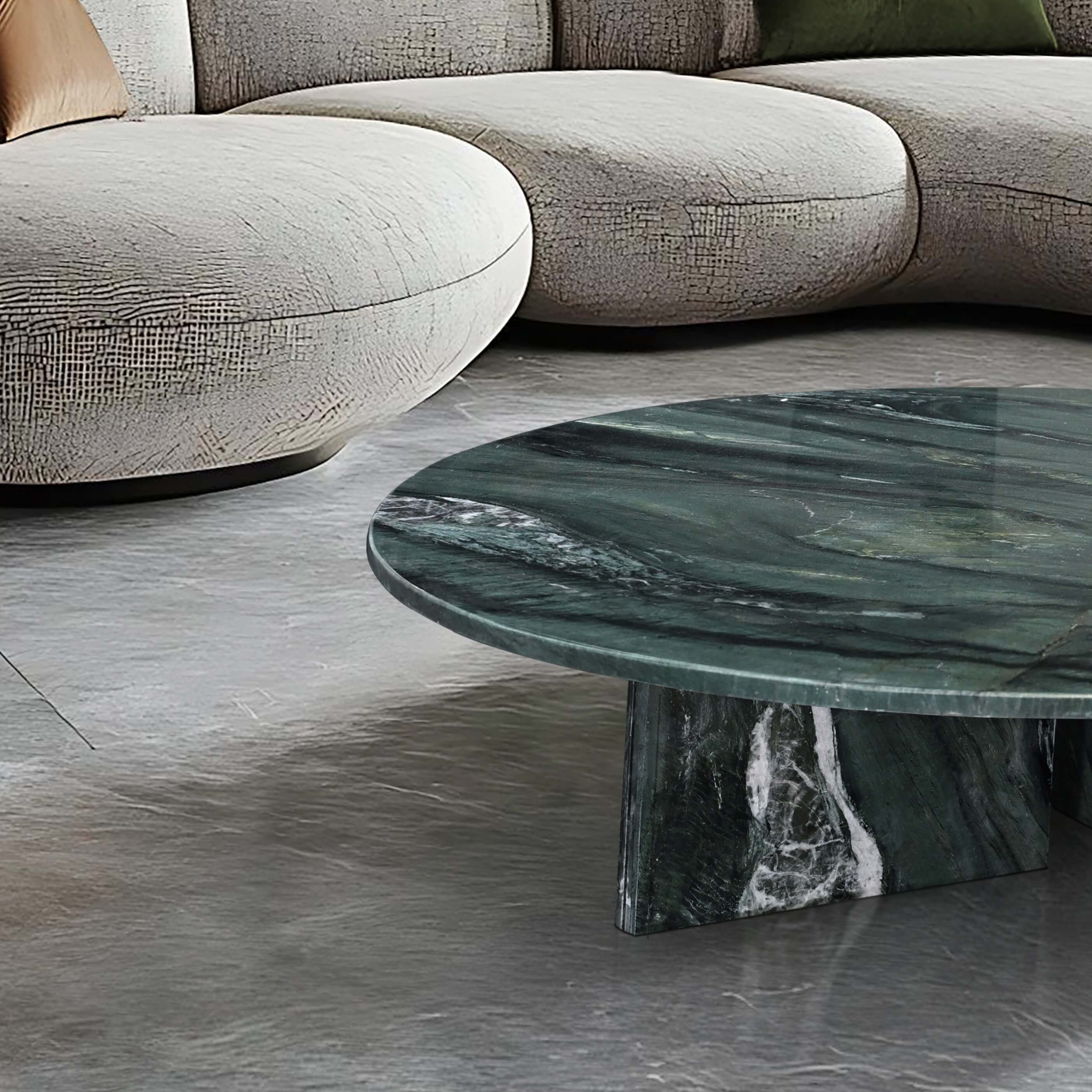 Top view of a polished Diamond Green marble coffee table glowing in warm sunlight, decorated with fresh orange flowers and coffee cups for a cozy home atmosphere.