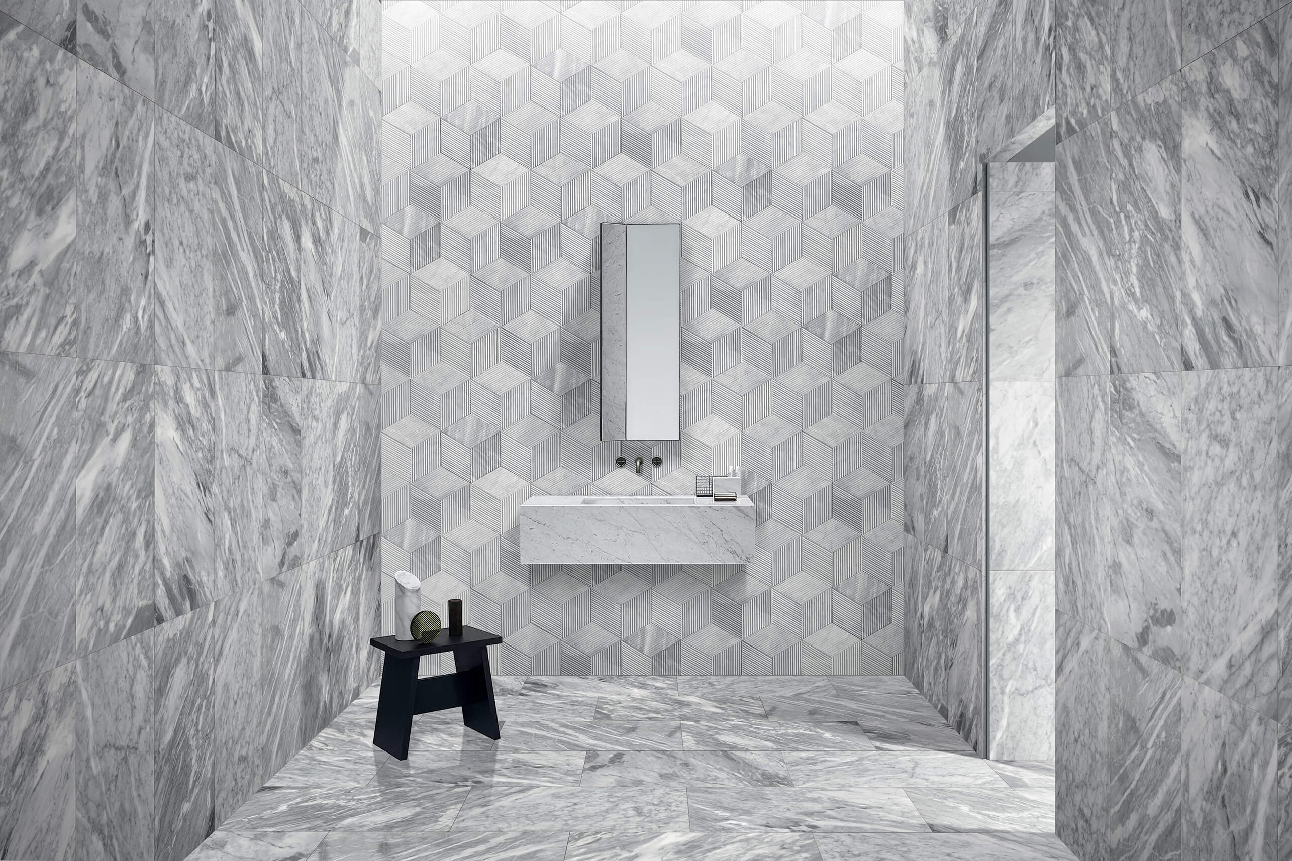 Stunning bathroom design combining 12x24 Carrara Gray polished marble tiles on floors and side walls with a striking Hexagon OL textured finished accent wall. 100% natural stone, creating a unique and luxurious space.