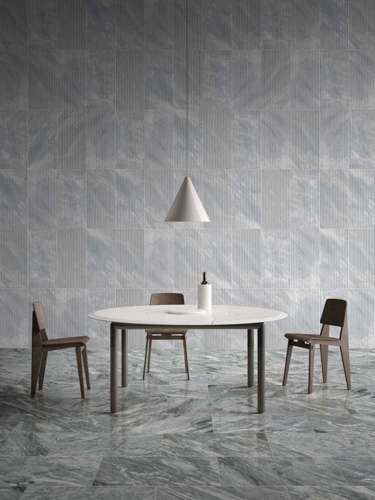 Elegant dining room design featuring 12x24 Carrara Gray polished marble floor tiles paired with OL textured finished wall tiles. 100% natural and unique stone.