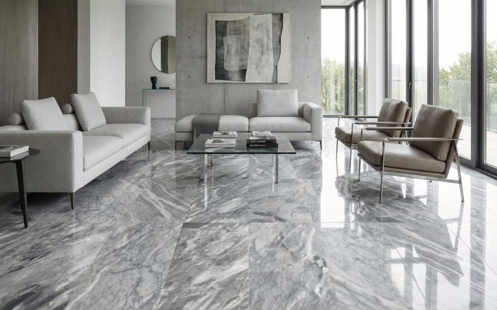 Contemporary living room design elevated by 12x24 Carrara Gray polished marble floor tiles. These easy-to-install, 100% natural marble pieces offer a sophisticated and unique aesthetic.