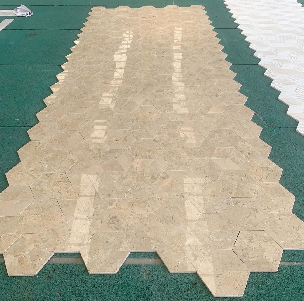 Large-scale factory layout of Hyatt Gold polished natural marble hexagon tiles, showcasing the breathtaking 3D cube effect and natural veining variations. A perfect high-end floor paving solution.