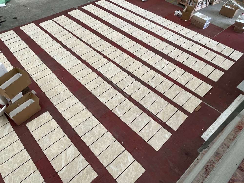 High-end 12x24 Hyatt Gold 3D fluted marble wall tiles laid out in the factory, highlighting ample USA warehouse stock for quick delivery.