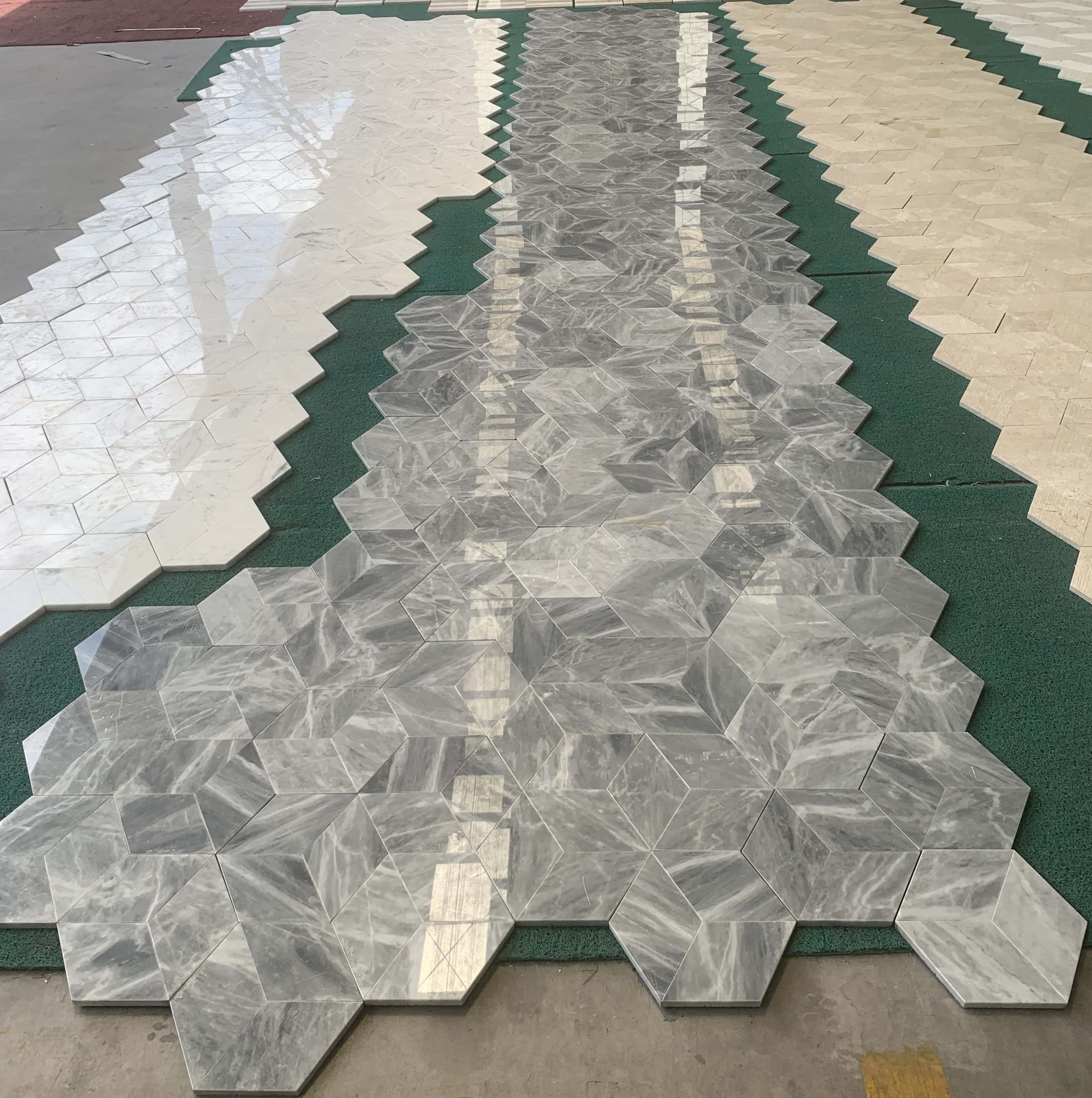 Large-scale paving layout of natural Carrara Gray marble tiles, demonstrating the beautiful, one-of-a-kind color and vein variations of the stone.