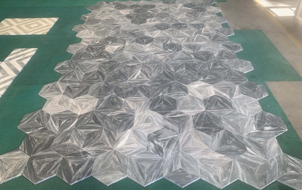 Large-scale factory layout of natural Carrara gray hexagon marble tiles, showcasing that 100% natural stone makes every single piece uniquely beautiful.