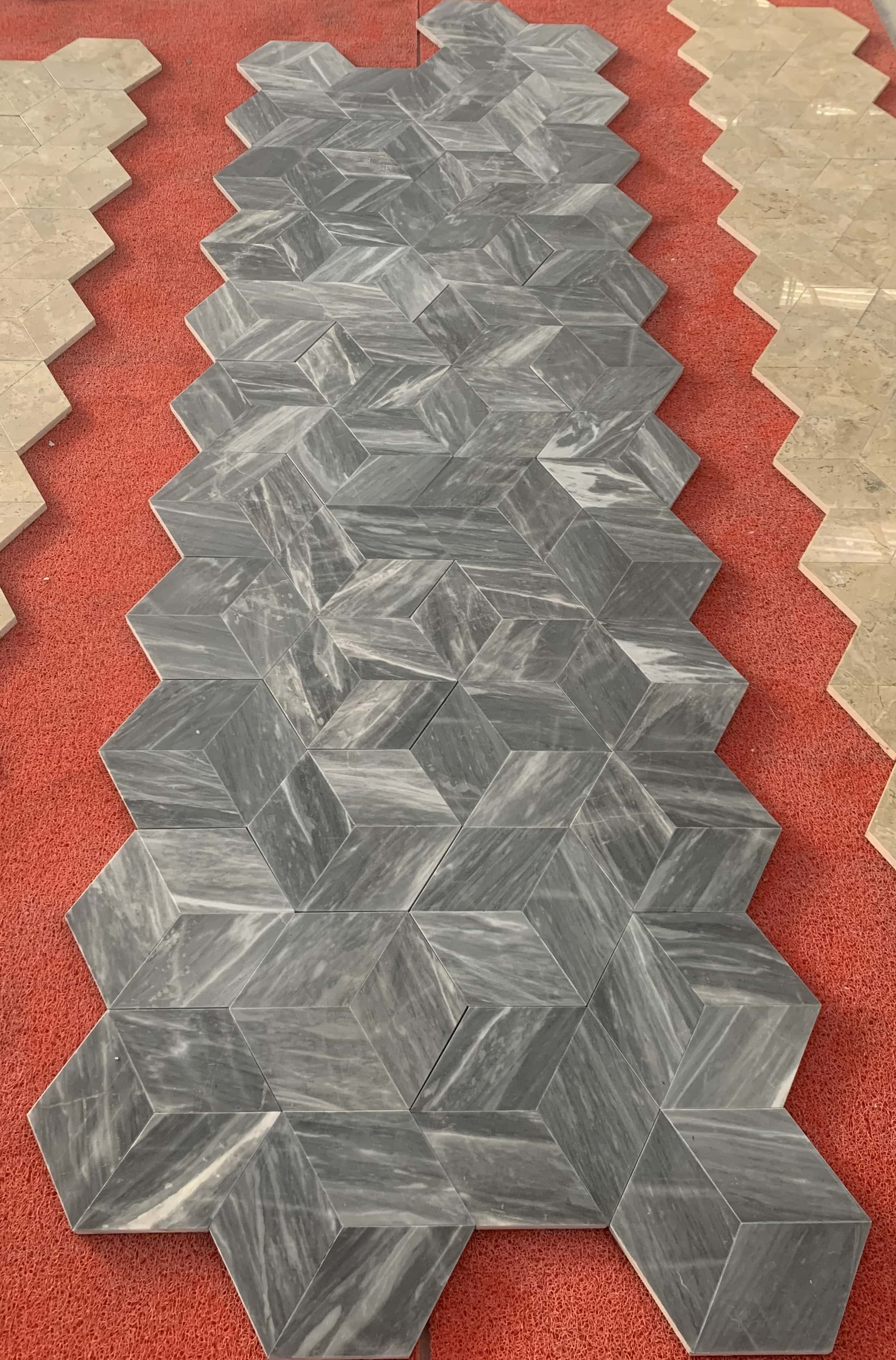 Premium Carrara gray 3D hexagon marble tiles laid out for an installation preview, demonstrating the exclusive high-end aesthetic of our natural stone products.