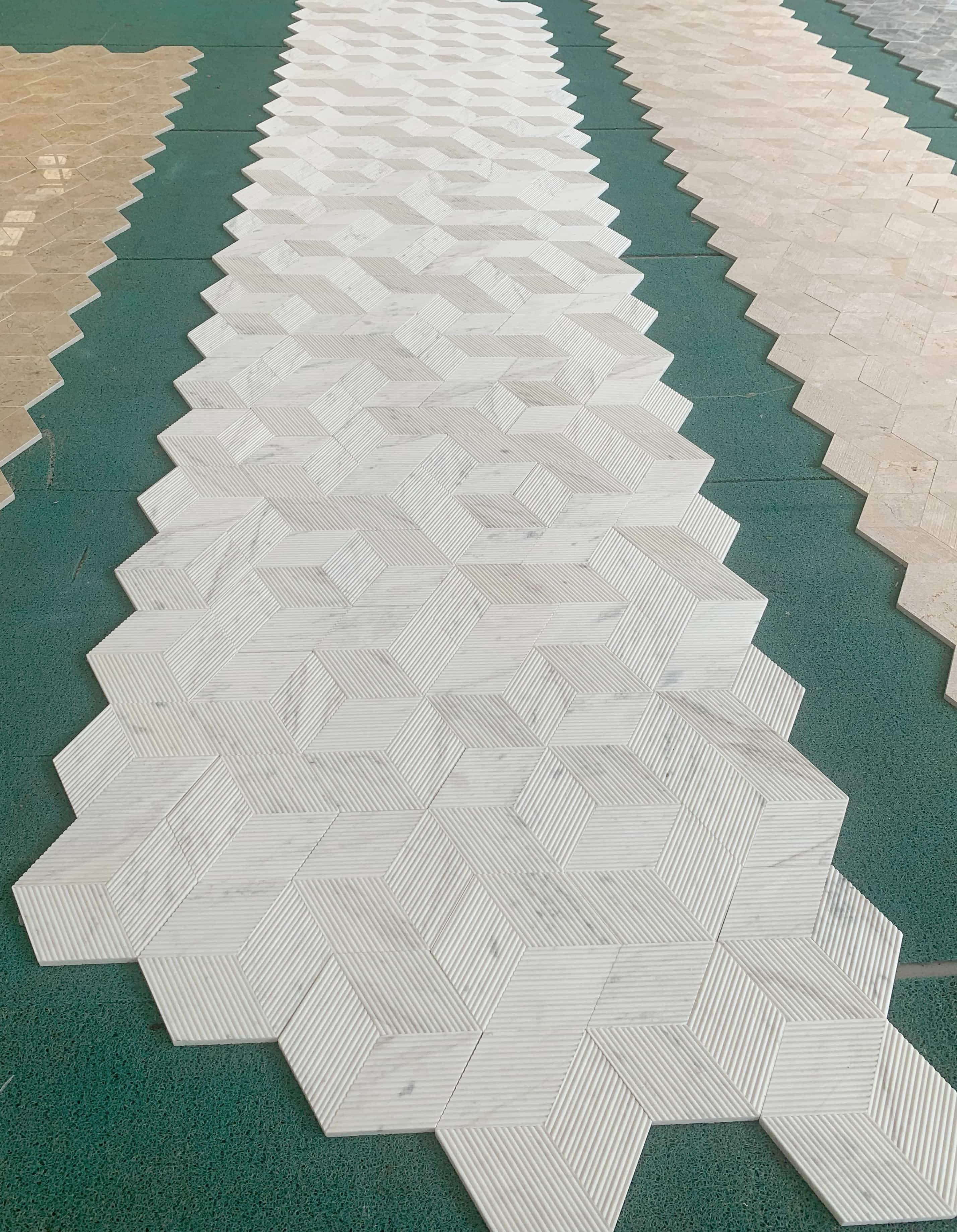 Large scale factory layout of our exclusive Snow Mountain White hexagon marble tiles, showcasing the unique and natural variations of every single piece.