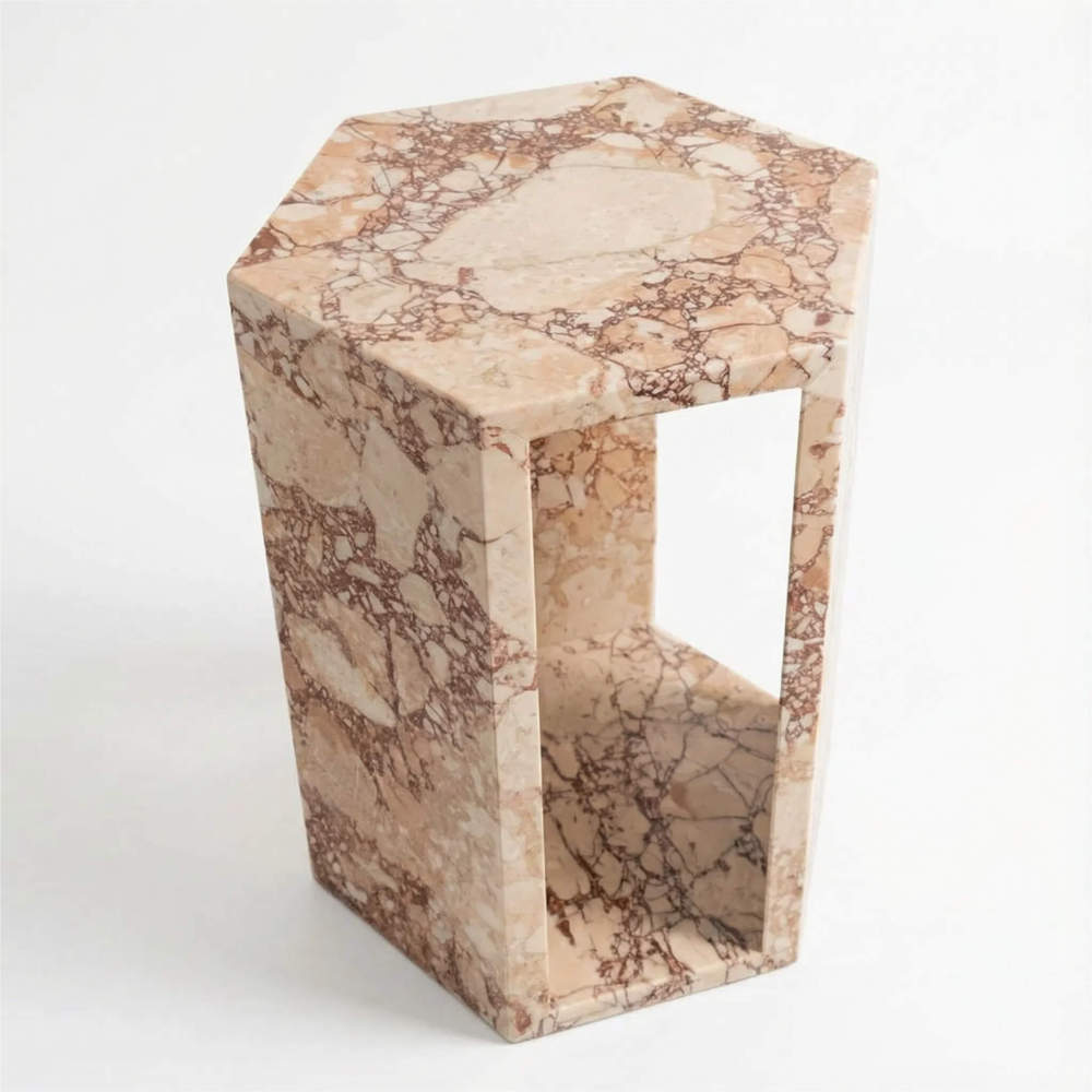 Angled view of the hexagonal solid marble end table, a perfect compact and modern accent stand for small living room spaces.