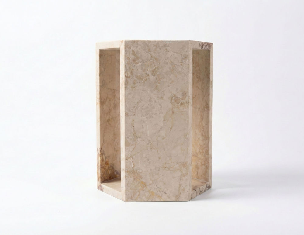 Angled view of the light pink geometric marble side table, highlighting the hollow design and 100% natural stone texture. Ready to use out of the box.