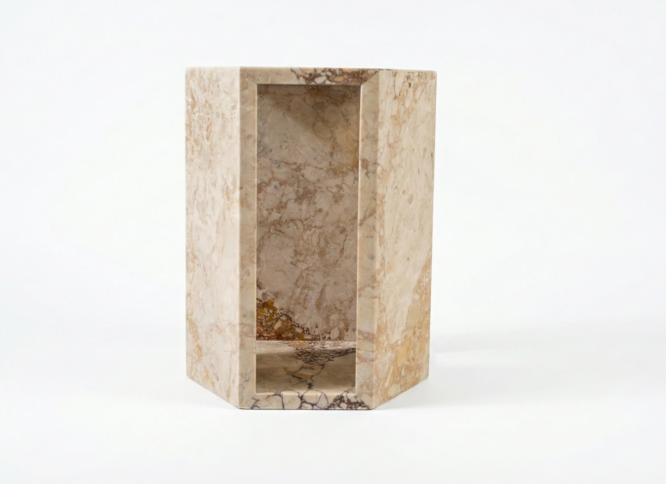 Front view of the luxury natural diamond pink marble hexagon side table featuring a unique hollow geometric center.