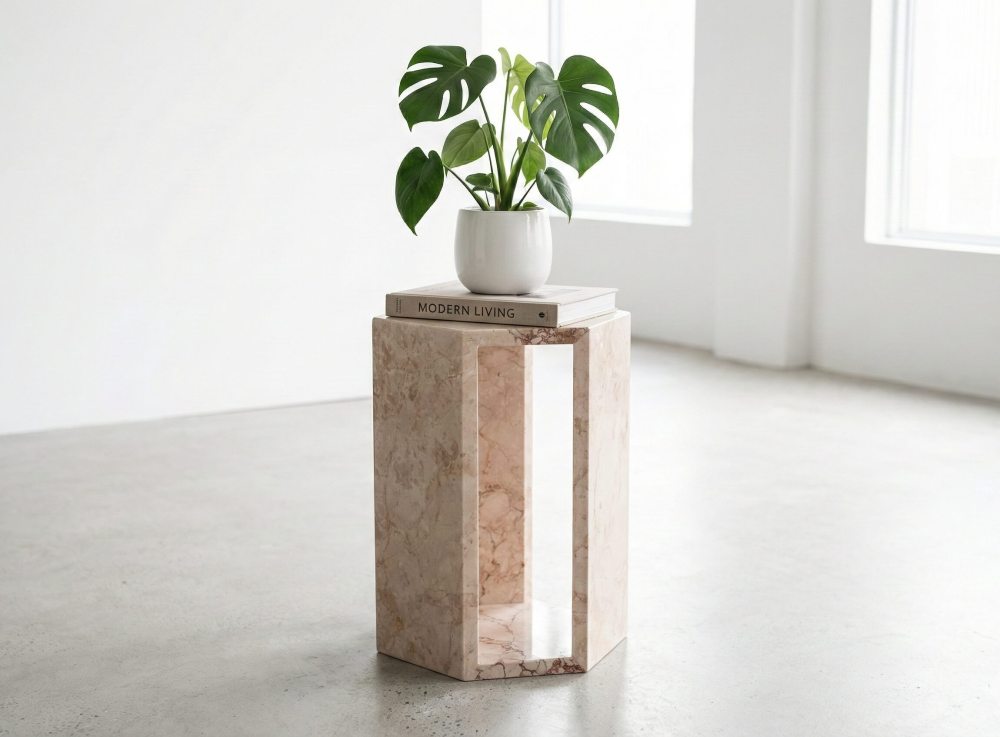 The modern hollow marble table used as an elegant plant stand in a minimalist space. Each 100% natural piece adds unique character to your home.