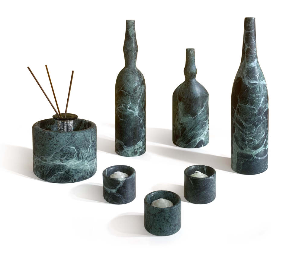 Diamond Green marble diffuser holder with reed sticks and three marble tealight holders with lit candles, demonstrating functional luxury home decor.