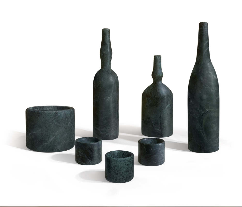 Luxury dark green marble sculptural vases and tealight holders arranged together, showcasing the 100% natural stone's unique emerald-like veining.