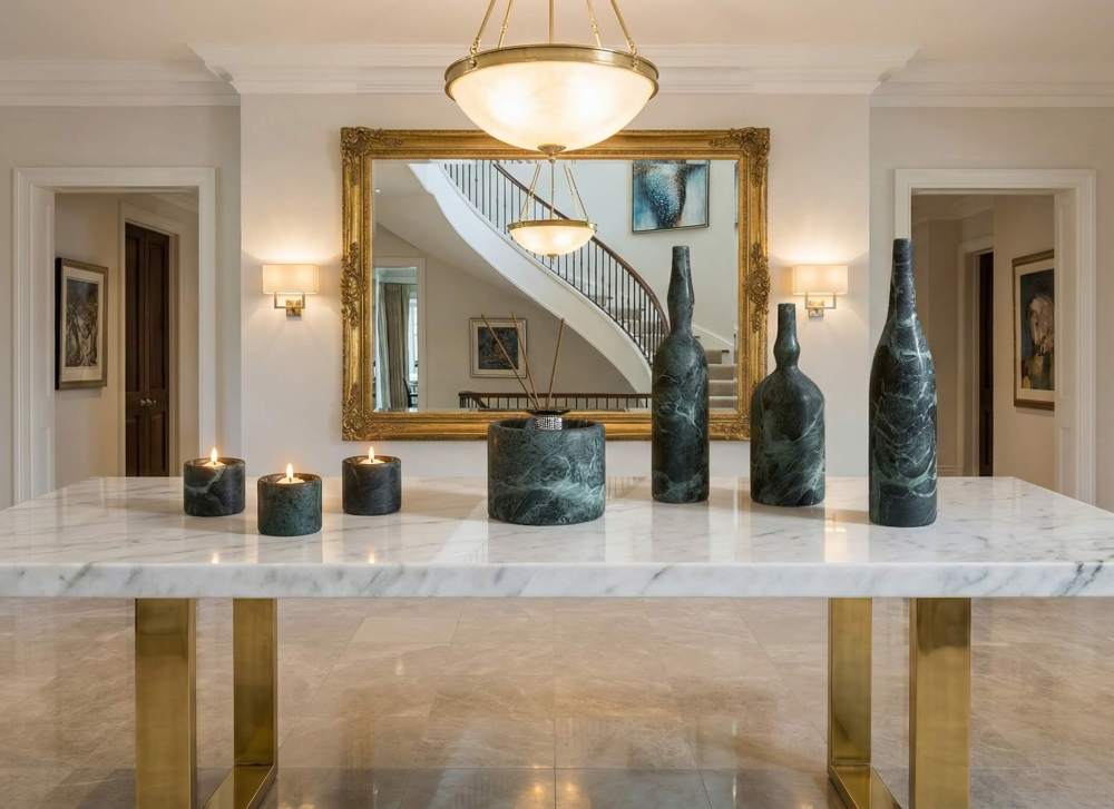 Grand entryway console table centerpiece featuring a 7-piece Diamond Green marble vase set styled in a luxury foyer with high ceilings.