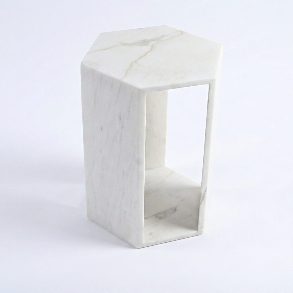 Angled view of the modern minimalist white marble drink table, featuring a geometric hexagonal design and soft matte stone surface.