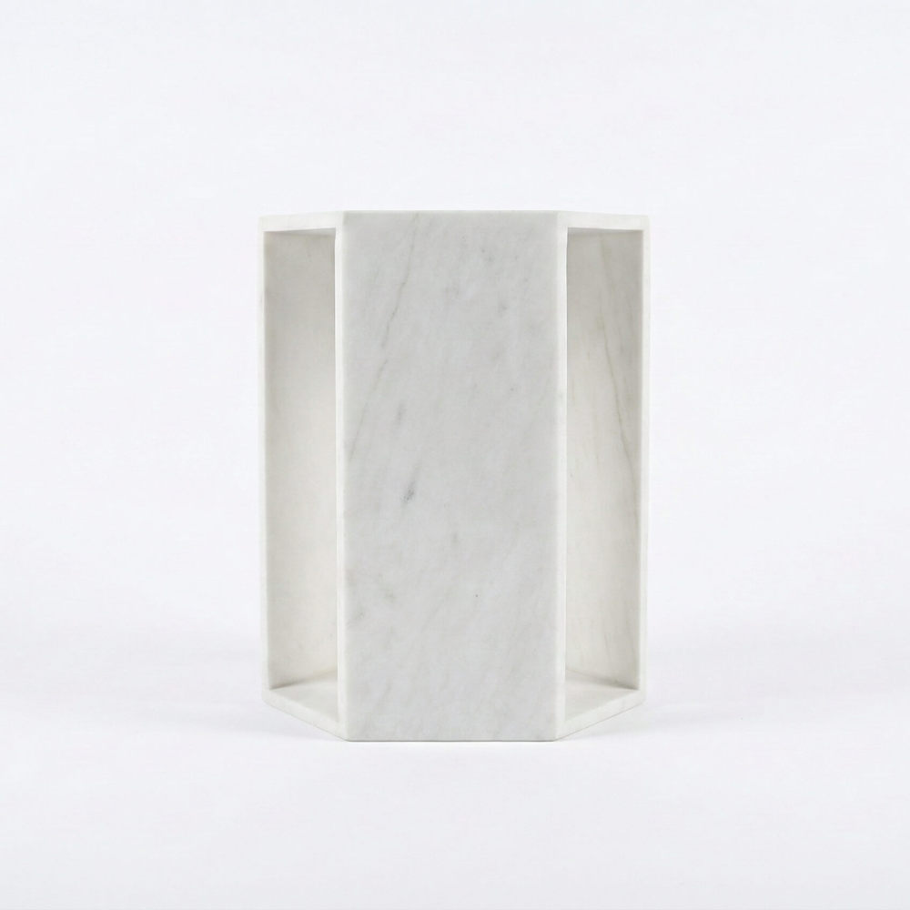 Front-facing view of the solid marble hexagonal pedestal stand, showcasing the genuine natural stone texture where every piece is truly unique.