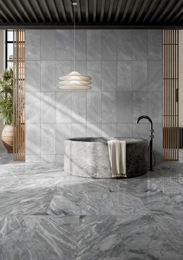 Modern bathroom blending 12x24 Carrara Gray polished marble floors with striking OL textured finished walls. This unique natural stone combo is in stock at our US warehouse.