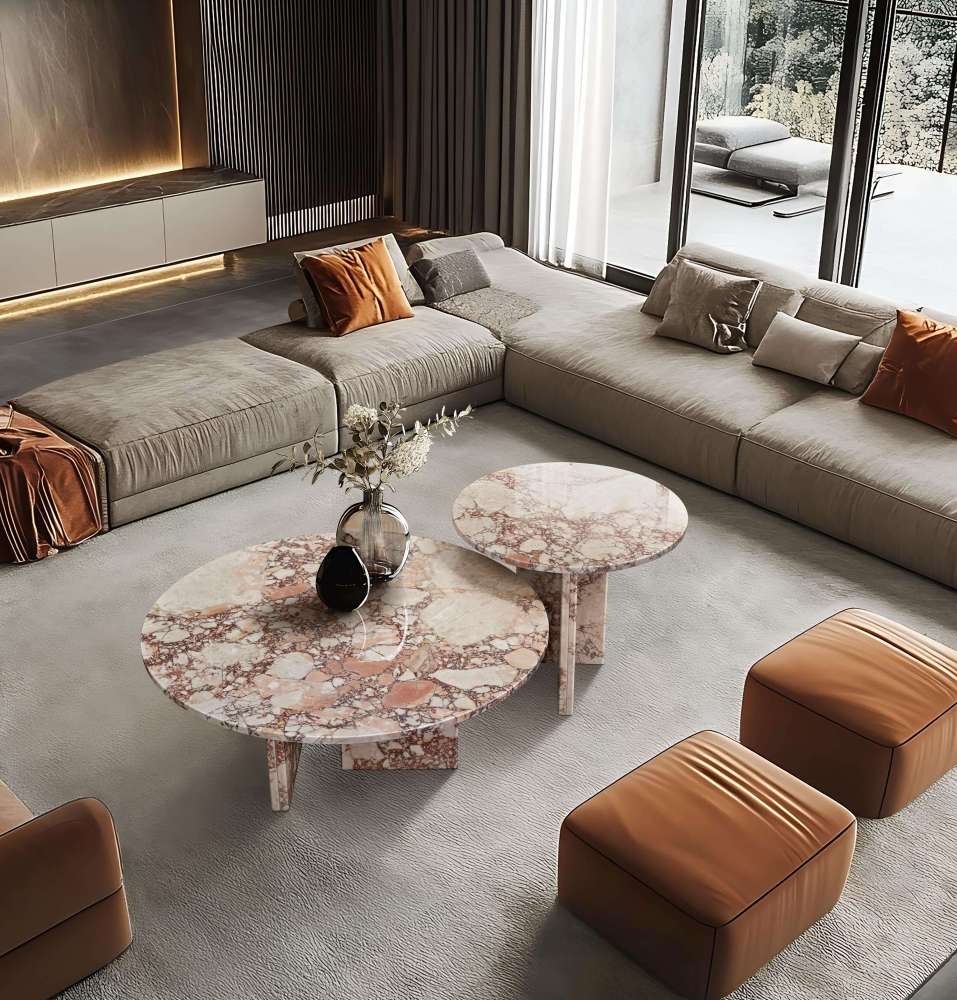 High-angle interior view of the round pink natural marble coffee table set. The polished finish and 100% real stone veins add a touch of authentic luxury to a contemporary living room setting.
