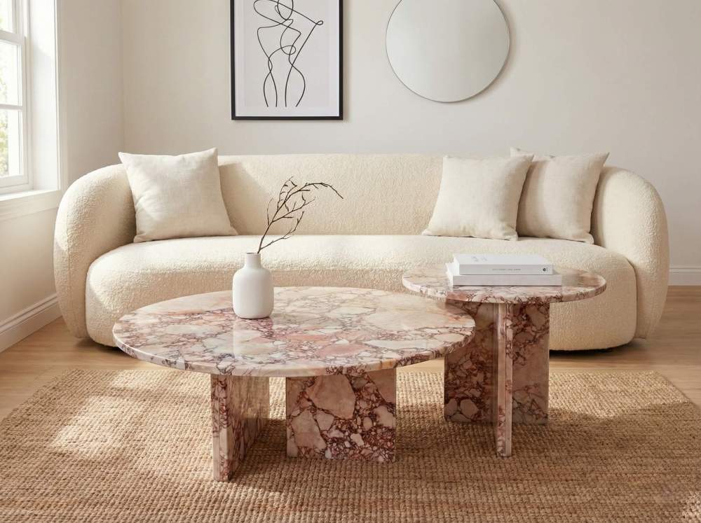 Organic modern living room showcasing the 2-piece natural pink marble nesting tables with a white boucle sofa. Easy to assemble, this authentic stone set brings earthy elegance to any space.
