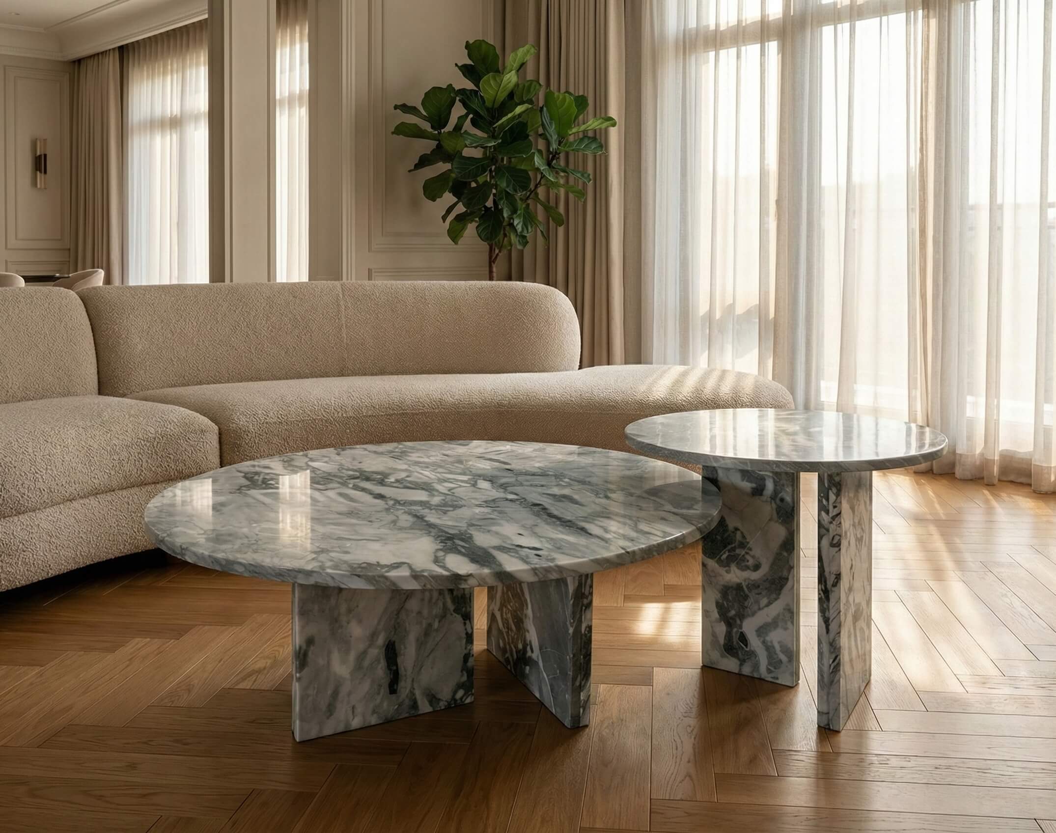 Natural Cloudy Blue marble nesting coffee tables illuminating a sunlit living room with herringbone floors. Order today with fast shipping from our US warehouse.