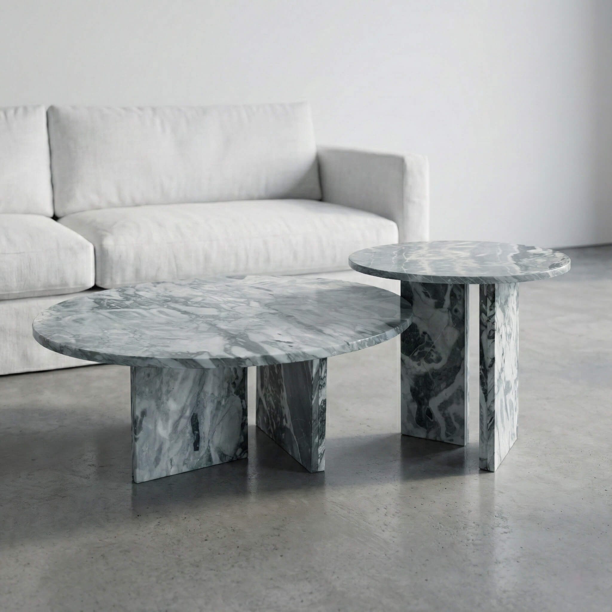 Side angle of the luxury Cloudy Blue marble round coffee tables enhancing a minimalist interior design, highlighting the natural stone's elegance and easy assembly structure.