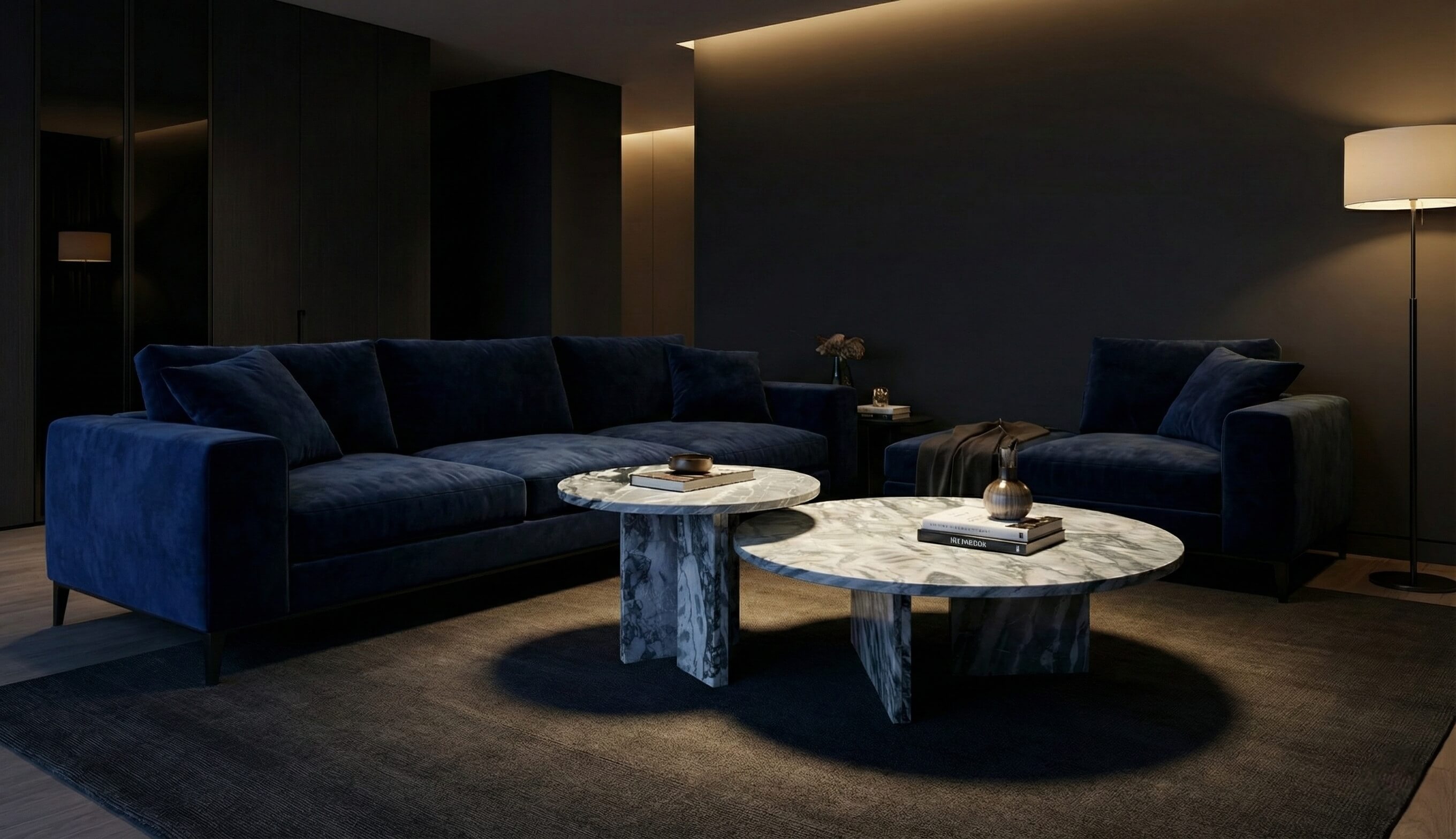 A moody, sophisticated living room setup featuring a blue velvet sofa alongside our exclusive Cloudy Blue natural marble nesting tables, currently in stock in the USA.