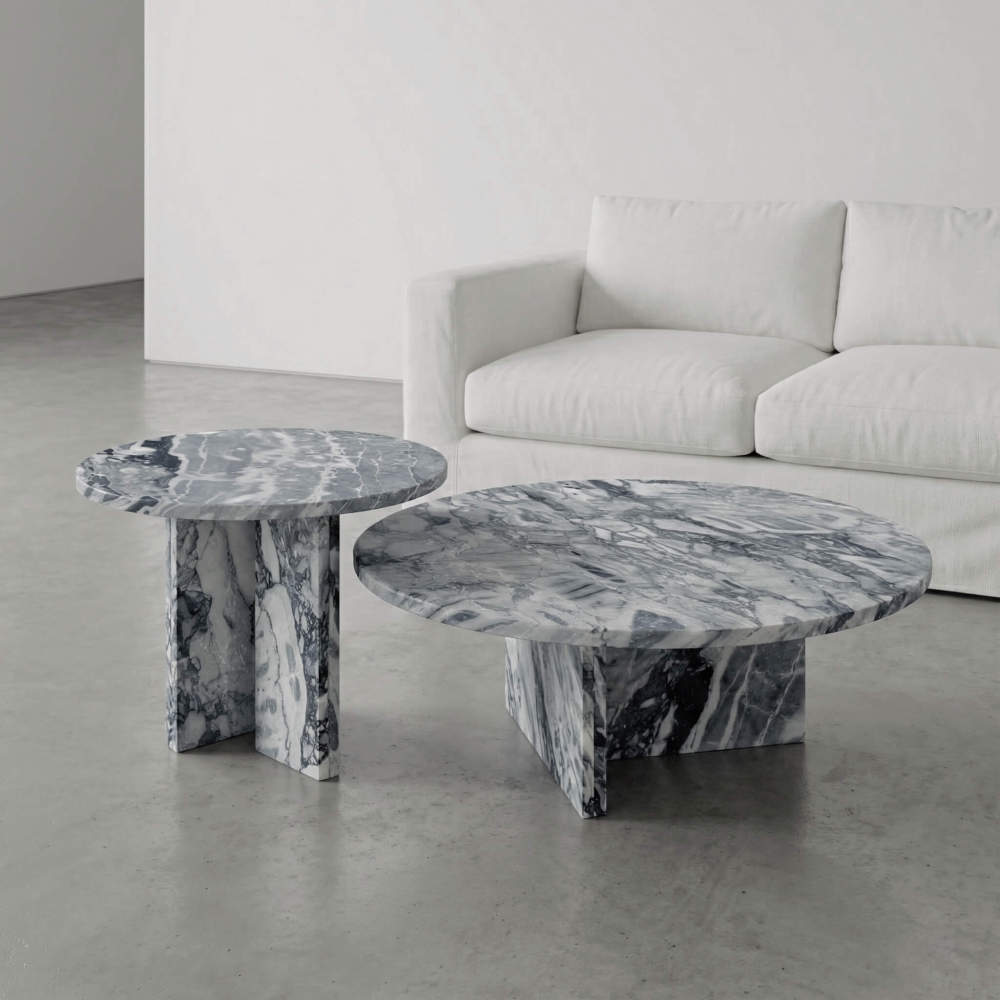 A luxury modern living room setting featuring the authentic Cloudy Blue natural marble nesting coffee table set as a stunning, one-of-a-kind centerpiece.