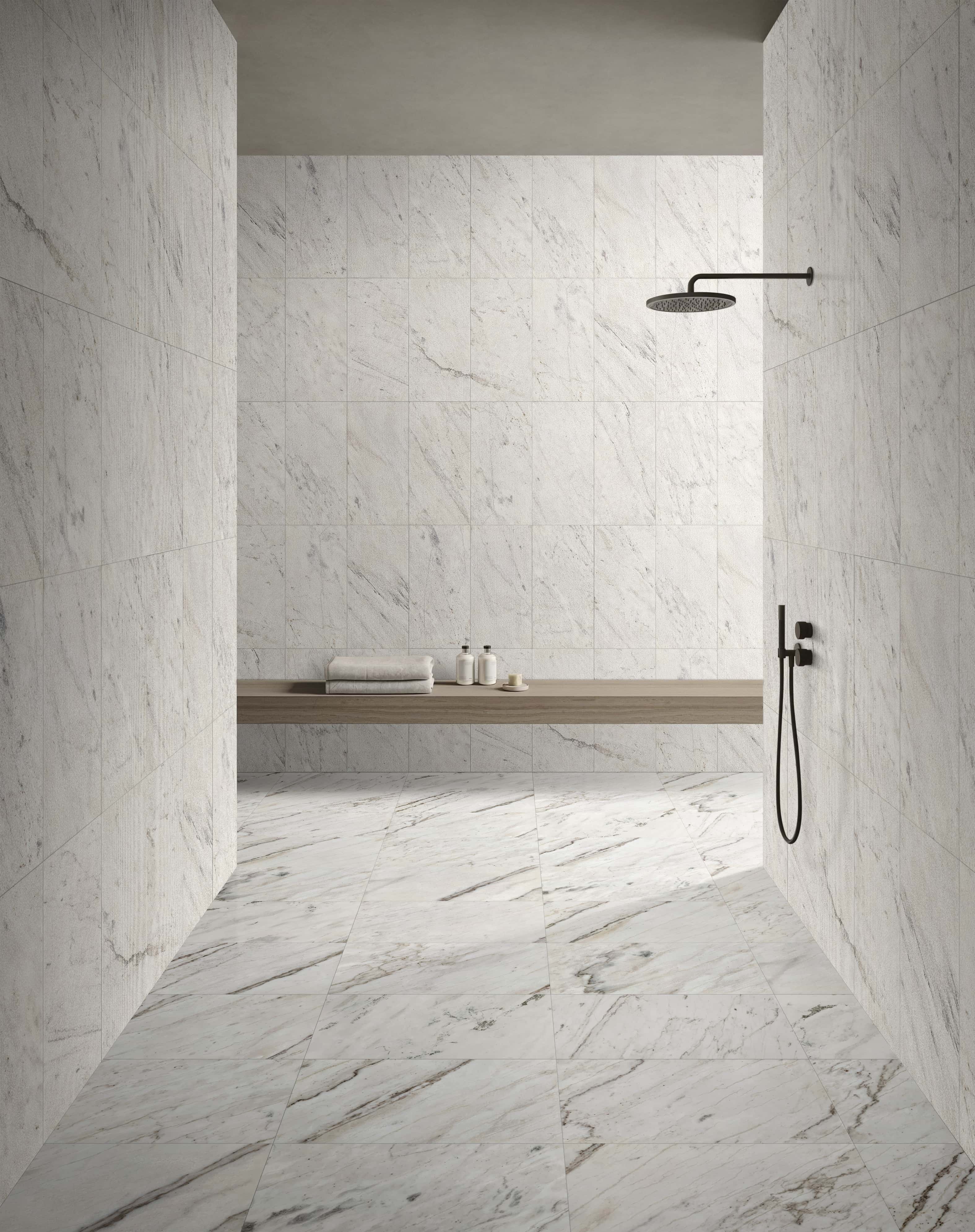 Modern minimalist bathroom featuring 12x24 Snow Mountain White polished marble floor tiles seamlessly combined with FS textured marble wall tiles.