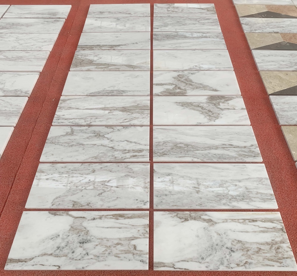 Authentic factory shot of premium polished marble tiles, highlighting the luxury aesthetic for residential and commercial projects.