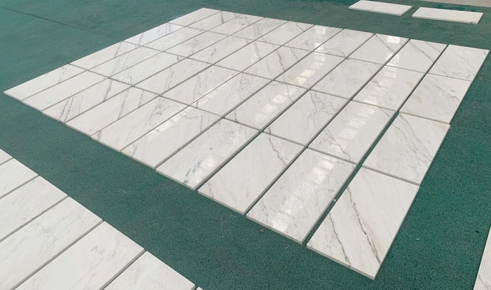 Professional factory inspection of 20mm thick polished white marble tiles ready for shipment.