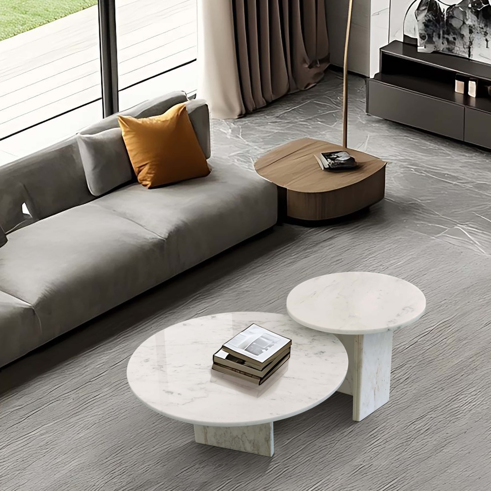 High-angle view of contemporary nesting marble center tables enhancing a minimalist living room interior design.