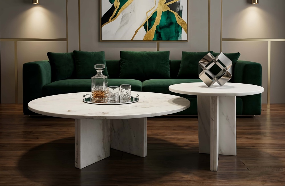 Genuine white marble nesting tables serving as a luxurious focal point in an elegant living room with a dark green sofa and brass accents.