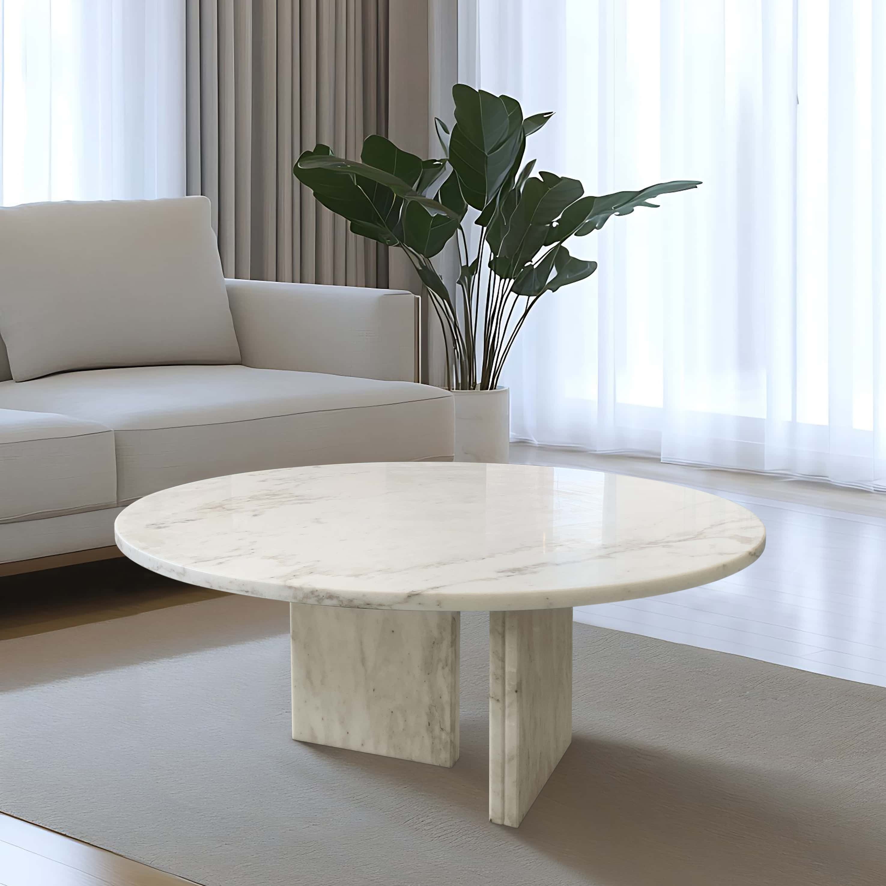 Snow Mountain White marble coffee table styled as a stunning centerpiece in a modern, light-filled living room. Enjoy free shipping on this genuine natural stone furniture.