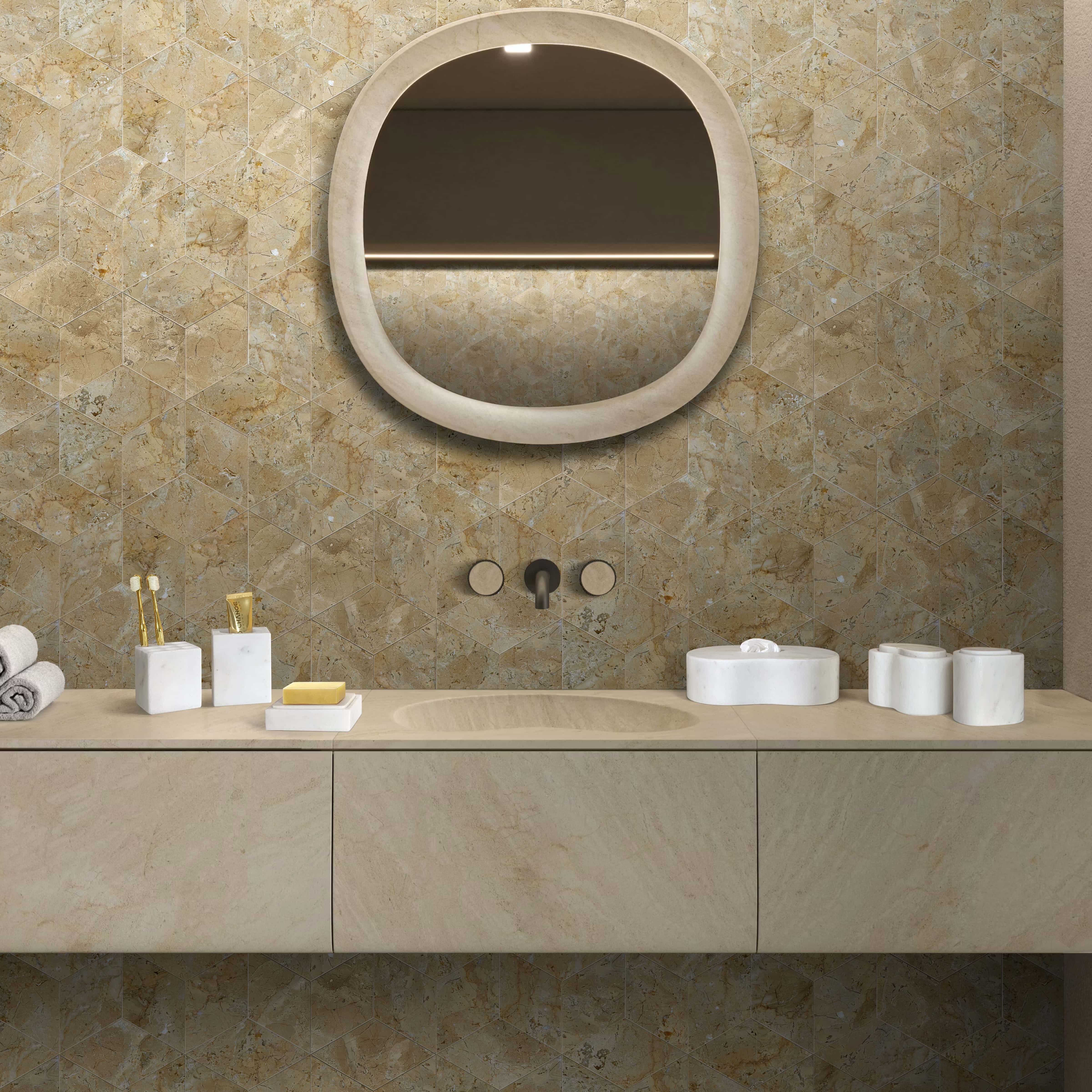 The complete 6-piece Snow Mountain White natural marble bathroom vanity set styled on a modern counter against a luxurious Hyatt Gold hexagon polished tile wall.