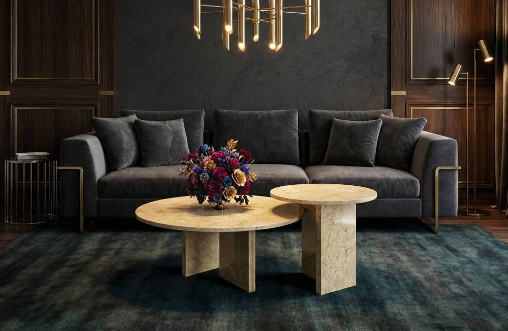 Classic luxury interior with dark wood panels featuring the Hyatt natural marble nesting coffee tables. The 28-inch and 18-inch unique stone tables bring sophisticated elegance to any room.