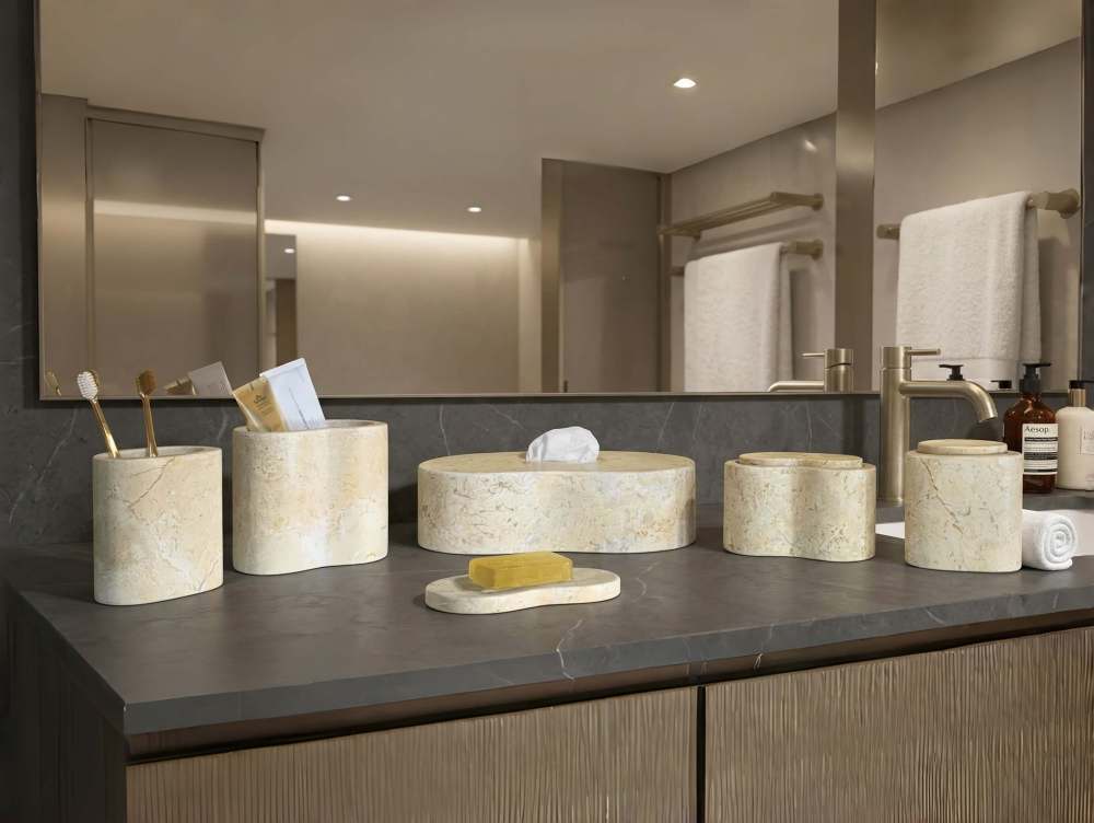 High-end luxury hotel style bathroom featuring the Hyatt Gold 6-piece marble set on a dark slate countertop, arriving safely in custom anti-damage protective packaging.