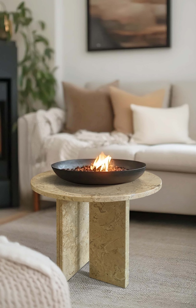 Beige natural marble coffee table by Luxury Marble Craft featuring a tabletop fire bowl in a cozy living room. The naturally heat-resistant stone is perfect for modern decor.