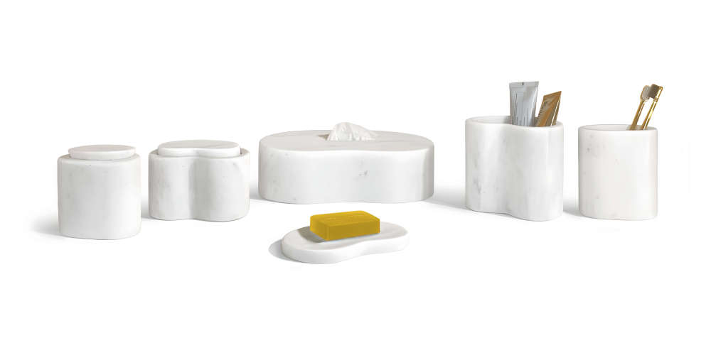 Snow Mountain White marble bathroom vanity set displaying practical use with toiletries, highlighting elegant and timeless bathroom decor.