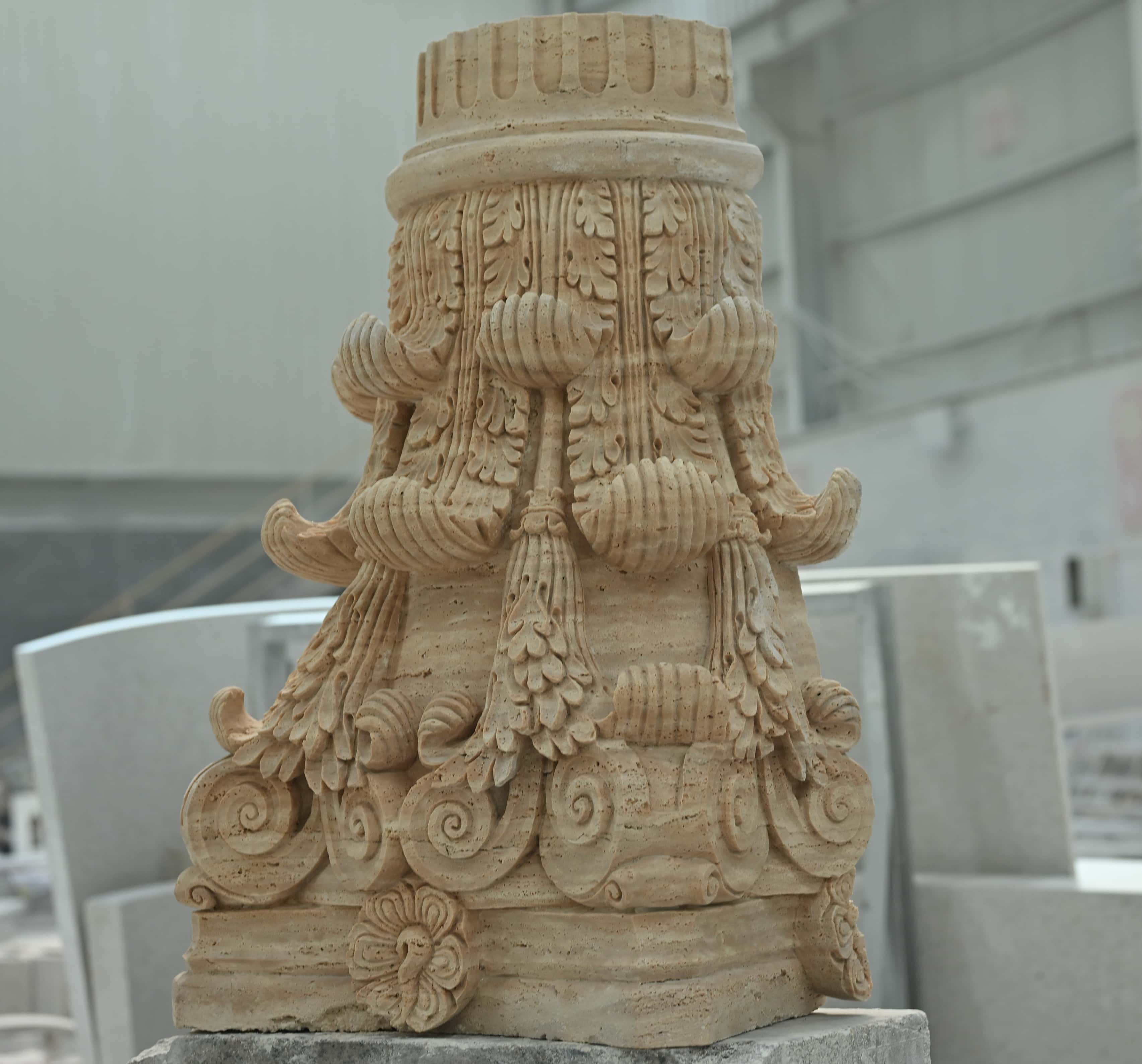 Bespoke hand and CNC carved natural stone architectural relief, showing delicate craftsmanship.