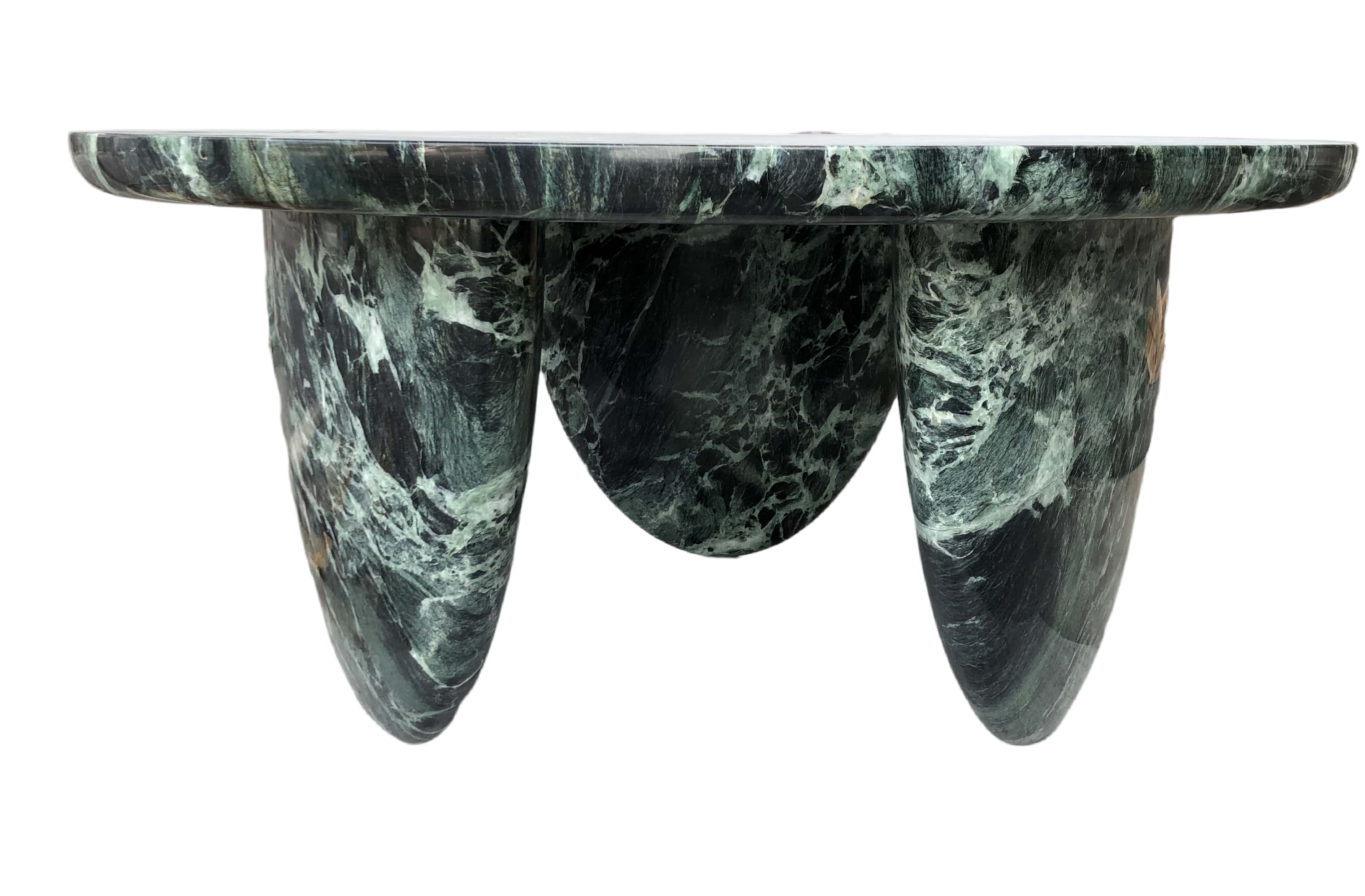 Custom natural stone furniture featuring a unique marble dining table for luxury interiors.