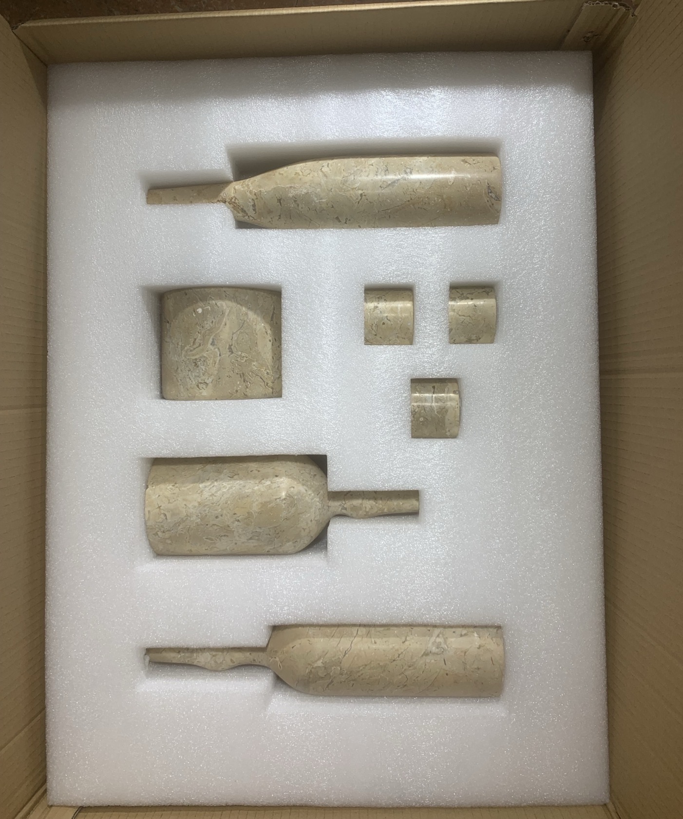 Custom die-cut secure foam inner packaging protecting the 100% natural marble decor pieces against impact during shipping.