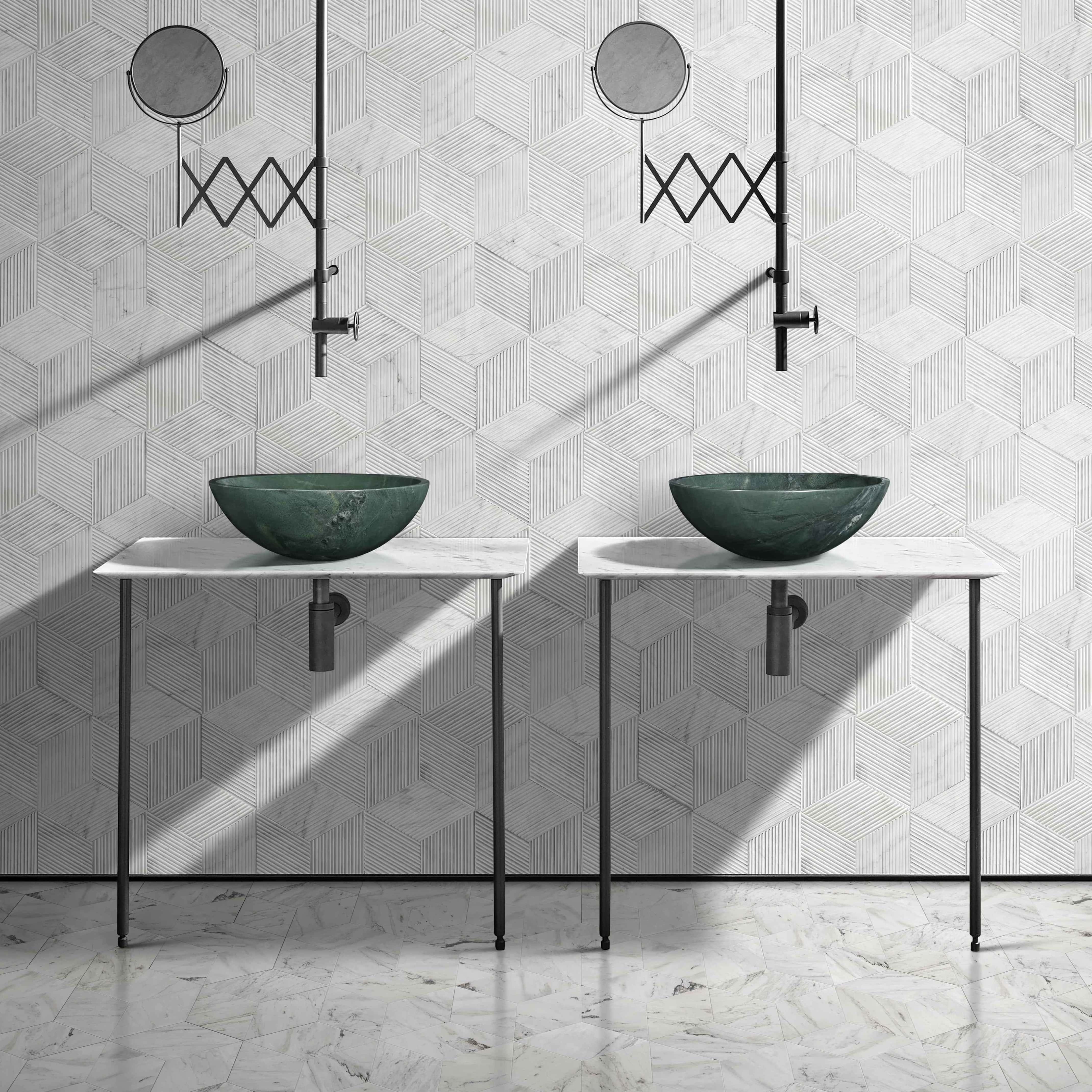 A stunning double vanity setup showcasing two diamond green polished marble vessel sinks. The vibrant green stone strikingly contrasts against the snow mountain white hexagonal textured wall tiles and polished marble floor tiles.