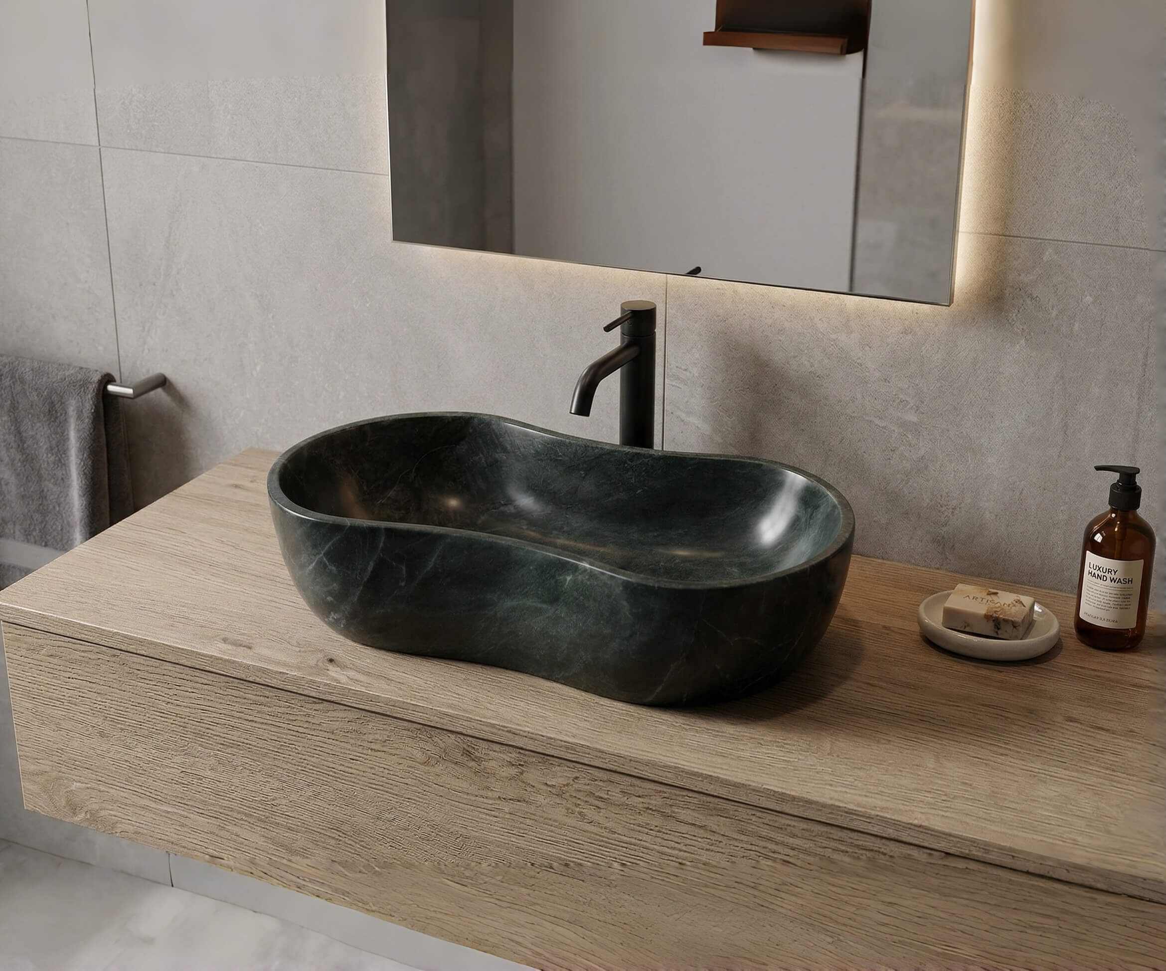 Modern organic bathroom vanity setup with a Diamond Green marble vessel sink on a light wood floating vanity, complemented by a matte black faucet.