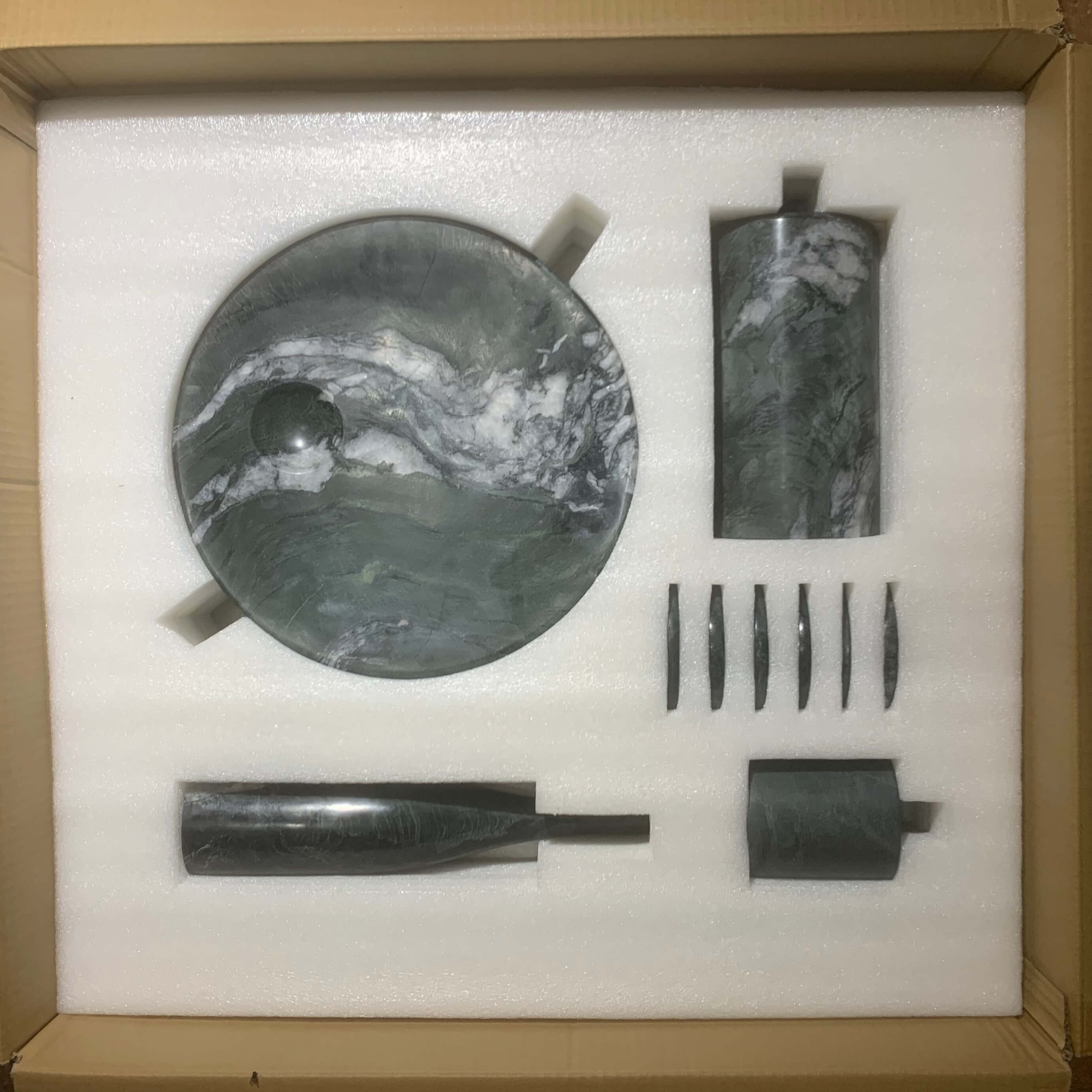 Interior view of custom-cut protective foam packaging inside a carton to ensure 100% safe delivery of fragile marble items.