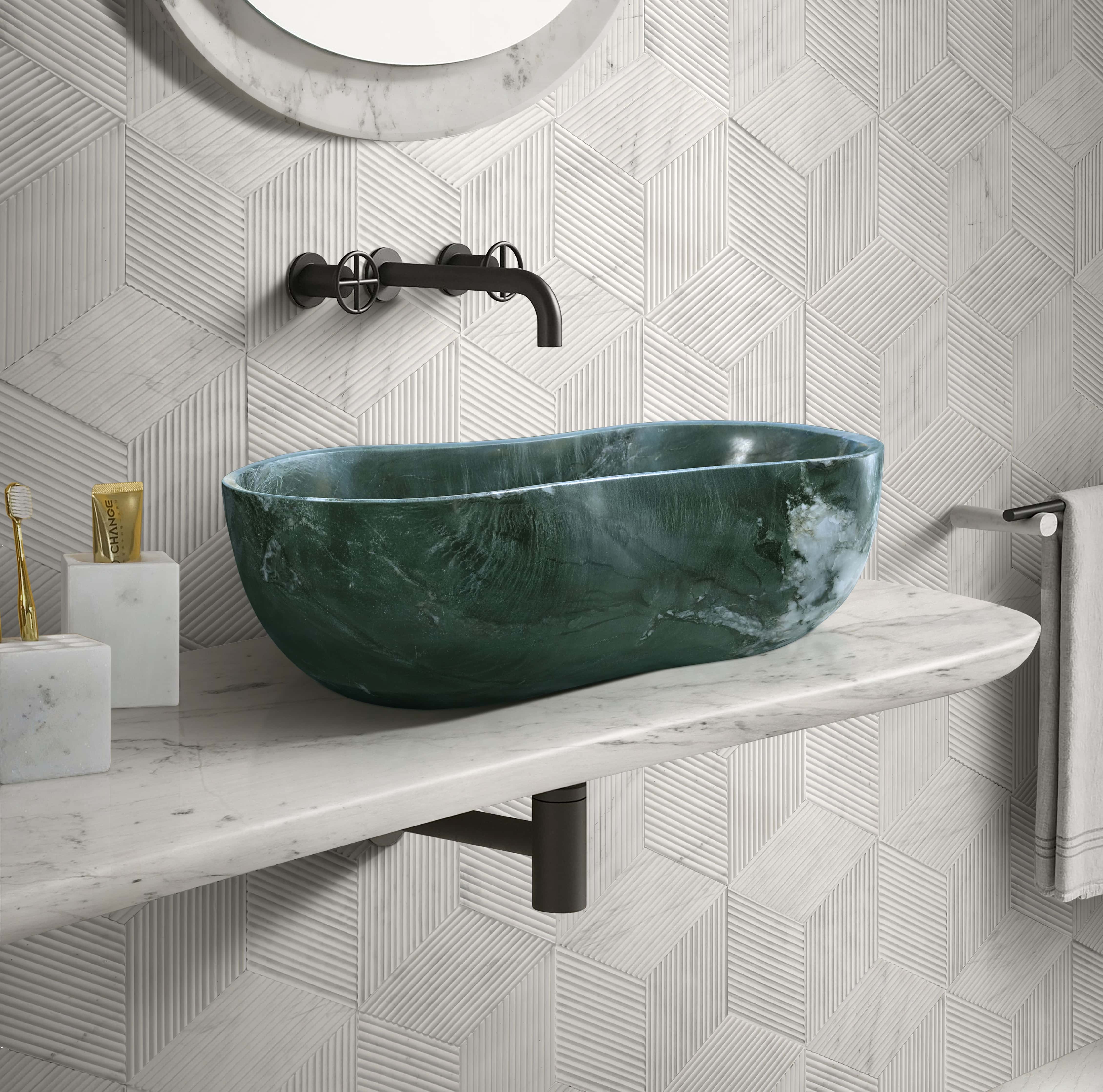 Minimalist vanity setup with Snow Mountain White hexagon OL textured wall tiles, a single Diamond Green oval marble vessel sink, and coordinating Snow Mountain White marble bathroom accessories.