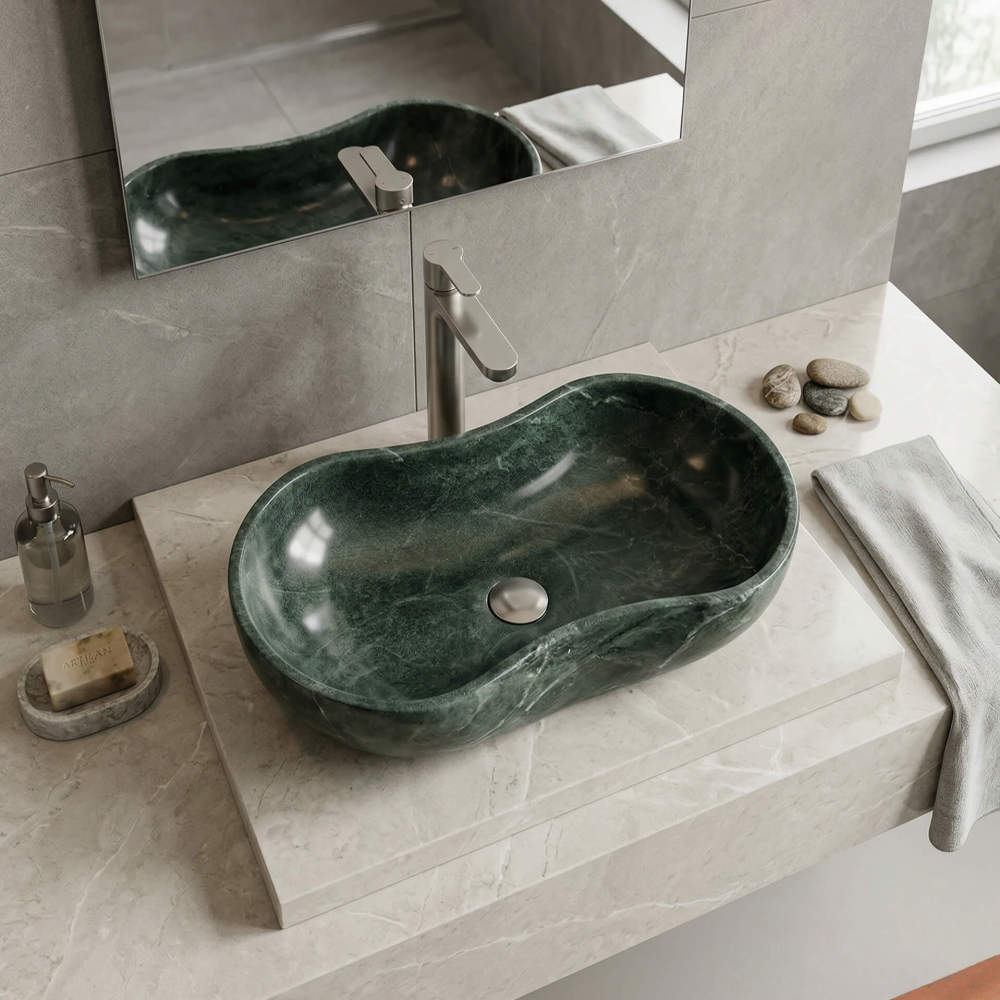 Diamond Green marble vessel sink with subtle natural patterns, installed on a beige marble countertop with a brushed stainless steel faucet and grey marble-textured wall tiles.