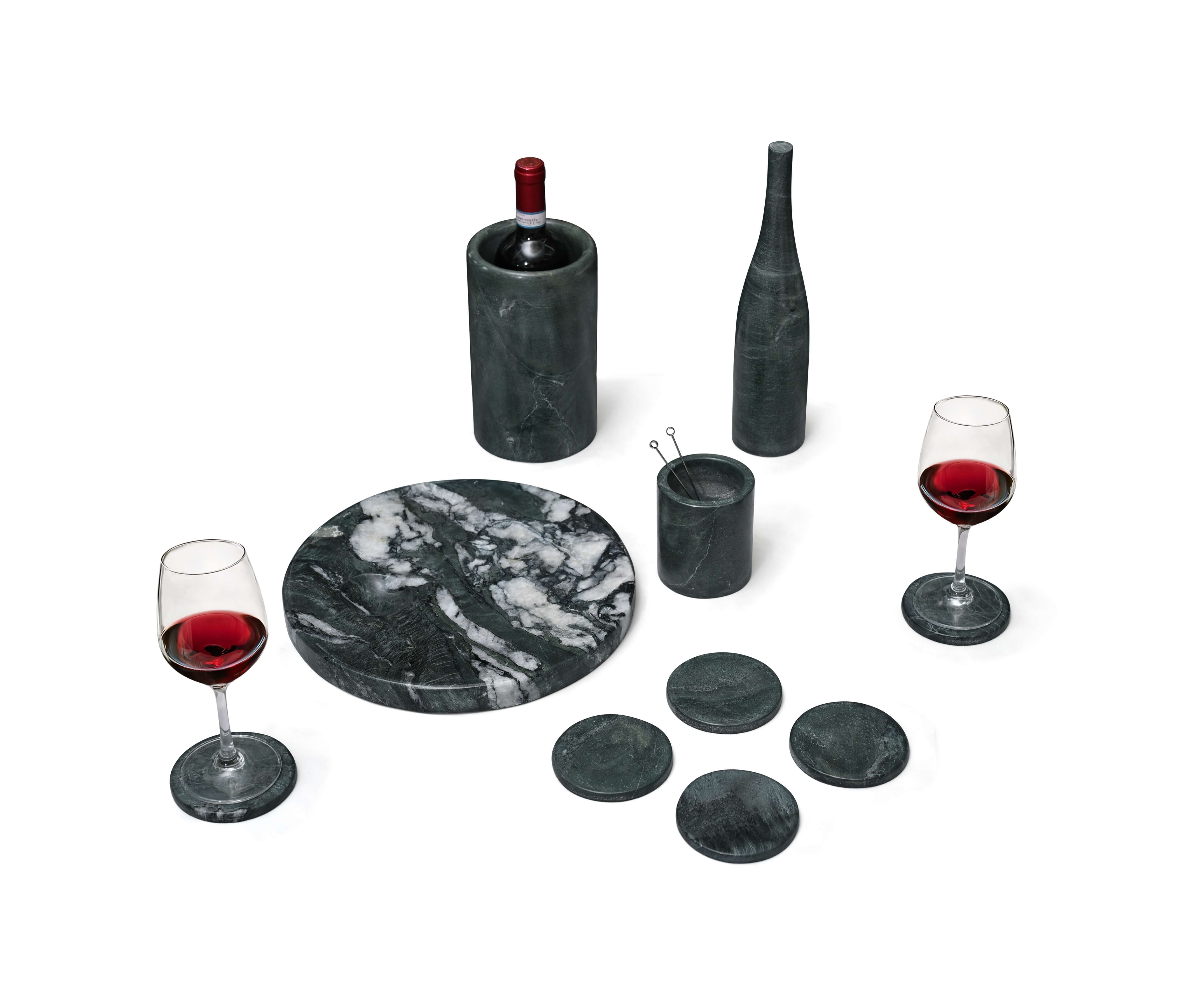 High-angle view of Diamond Green marble barware set showing the unique white veining on the circular tray and matching stone coasters.